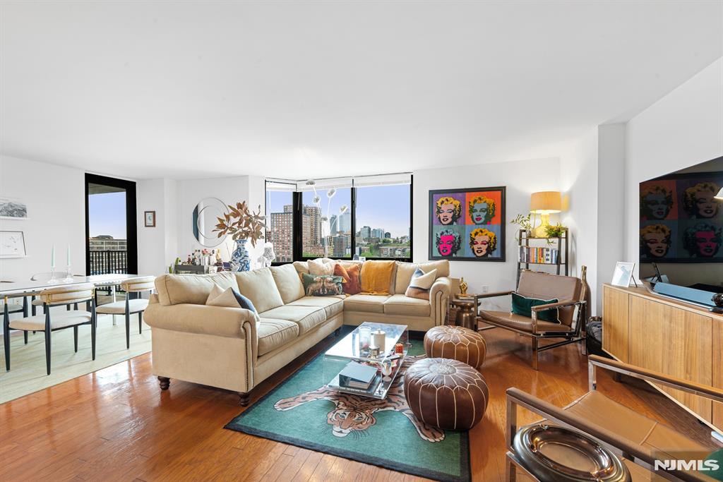 Step into this 2 bedroom 2 bathroom unit for luxury living at 700 Grove! Sun filled western exposure provides an abundance of natural light and beautiful sunsets. Gourmet kitchen with granite countertops, breakfast bar & SS appliances opens to an expansive dining and living area. The spacious primary bedroom offers a walk-in closet and connects to an en-suite bathroom featuring a large soaking tub, separate shower & double sink vanities. The guest bedroom also has an ensuite walk-through bathroom and spacious closet. Enjoy the convenience of an in unit washer and dryer, deeded garage parking, and views of Jersey City from the private terrace. Residents of 700 Grove enjoy premier amenities including a 24-hour doorman, state-of-the-art fitness center, residents' lounge, kids' play area, and a private shuttle to the PATH for effortless commuting. The HOA fee conveniently covers a preset cable package, high-speed internet, and all utilities except electricity. Enjoy the beautifully renovated entry, hallways, community room, and common spaces.