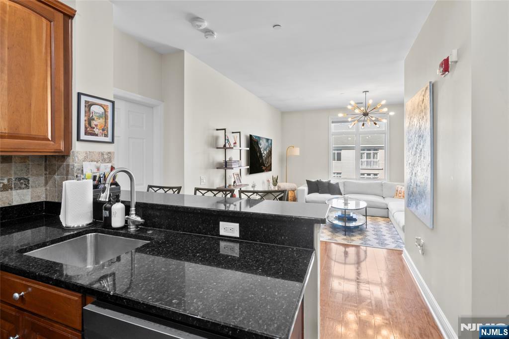 Discover this beautifully maintained, move-in ready 2-bedroom, 2-bath residence at the sought-after Hudson Pointe along the Hudson River. Spanning 1,089 sq ft, this desirable corner unit offers dual exposures, filling the home with abundant natural light throughout the day. The open-concept layout features a modern kitchen with stainless steel appliances and granite countertops, seamlessly flowing into a spacious living and dining area, perfect for both everyday living and entertaining. The primary suite includes a walk-in closet and a private en-suite bathroom, while the generously sized second bedroom offers ample closet space and flexibility for guests, a home office, or additional living needs. This home has also been updated with a new AC/furnace system and water tank, offering added comfort and peace of mind for the next owner. Residents enjoy a full suite of amenities, including a 24-hour doorman, fitness center, outdoor pool, business center, and cinema room. The cinema room, community room, conference room, and lobby have all been recently and fully renovated, enhancing the buildingâ€™s upscale appeal. This home also includes two garage parking spaces (one assigned and one floating) and offers convenient access to NYC, making it an ideal blend of comfort, style, and location.