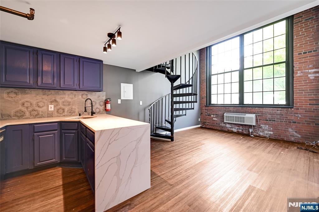 Great opportunity to rent this amazing loft-style duplex! This large 2-bedroom features, on the first floor, a modern open-concept living/dining room and kitchen, a bathroom. and, a large bedroom. On the second level a bedroom loft-style. Enjoy hardwood floors throughout, large windows, and cathedral ceilings. In addition, it comes with an assigned parking space and in-building laundry. *Photos taken before current tenants*