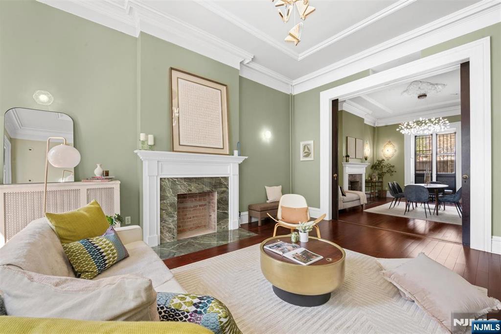 June 28 open house is by appointment only. Welcome to 274 Barrow Street, a rare opportunity to own a large 3-family brownstone in the heart of Downtown Jersey City, directly across from Van Vorst Park. Situated on a coveted 25x100 corner lot, this property offers the exceptional luxury of 3-car garage parking and impressive 14-foot ceilings throughout. The owner's duplex is currently vacant and features 2 bedrooms, 2 full bathrooms, and direct access to a private backyard, providing the perfect blend of space, privacy, and outdoor living. The second-floor residence offers 2 bedrooms and 1 bathroom, while the top-floor unit also features 2 bedrooms and 1 bathroom, creating excellent income-producing potential. Ideal for owner-occupants seeking the feel of a single-family home with the benefit of rental income, this well-positioned brownstone combines size, flexibility, and an unbeatable location in one of Downtown Jersey City's most desirable neighborhoods. Conveniently located near shops, restaurants, transportation, and all that downtown living has to offer, 274 Barrow Street presents a rare opportunity to own a classic brownstone with substantial income potential in a premier downtown location.