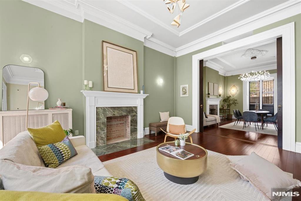 ** Public Open House June 20th between 1pm-3 pm, by appointment only on June 21st between 1pm-3 pm. *** Welcome to 274 Barrow Street, a rare opportunity to own a large 3-family brownstone in the heart of Downtown Jersey City, directly across from Van Vorst Park. Situated on a coveted 25x100 corner lot, this property offers the exceptional luxury of 3-car garage parking and impressive 14-foot ceilings throughout. The owner's duplex is currently vacant and features 2 bedrooms, 2 full bathrooms, and direct access to a private backyard, providing the perfect blend of space, privacy, and outdoor living. The second-floor residence offers 2 bedrooms and 1 bathroom, while the top-floor unit also features 2 bedrooms and 1 bathroom, creating excellent income-producing potential. Ideal for owner-occupants seeking the feel of a single-family home with the benefit of rental income, this well-positioned brownstone combines size, flexibility, and an unbeatable location in one of Downtown Jersey City's most desirable neighborhoods. Conveniently located near shops, restaurants, transportation, and all that downtown living has to offer, 274 Barrow Street presents a rare opportunity to own a classic brownstone with substantial income potential in a premier downtown location.