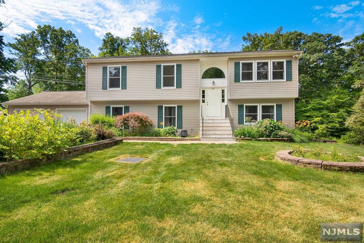 This home is certain to leave you breathless. Perfectly placed at the end of a quiet street, surrounded by parkland, this stunning bi-level offers serenity and privacy yet is only a stones throw away from Greenwood Lake's south shore marina. Entertaining is a delight in the updated kitchen with granite countertops and expanded breakfast bar or perhaps sipping cocktails on the 12 x 12 deck as you take in the views just outside the dining room sliders. Your guests will be green with envy as they stroll through this 2500 sq ft beauty with all of its upgrades. The oversized master and on suite are delightful with a huge WIC. The enormous 3rd bedroom is not to be overlooked as it offers privacy and its own WIC. The media room offers additional space to relax plus the family room doubles as an exercise room or office. Exit the family room through the sliders to the lower patio and take a walk through the large yard covering 3/4 of an acre. The bathrooms have new quartz countertops