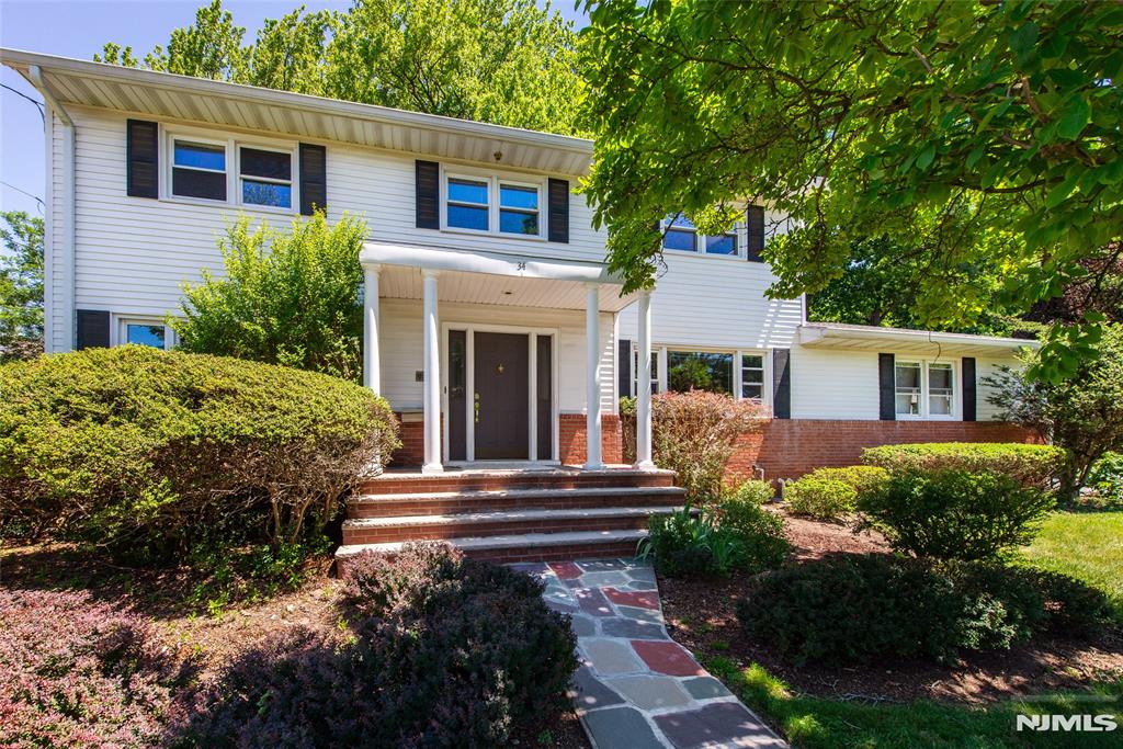 Welcome to this beautiful, light-filled Center Hall Colonial in the prestigious North Cliffs of Englewood Cliffs, one the area's most desirable neighborhoods. This approx. 2800 SQFT house offers 5 bedrooms and 2.1 bathrooms. Large entrance hall leads to a big living room, dining room & family room all beautifully detailed w/ moldings & paneling. The kitchen is large & bright w/ 2 skylights over the middle island, granite countertops & custom made cabinets & top stainless steel applcs. A bedrm/office, laundry & powder room complete the 1st floor. On the 2nd floor, there is a spacious master suite w/ 2 closets, 3 add'l bedrooms & an updated full bath. The full & finished basement for entertainment. Nice landscaping with sprinklers system. Hardwood floor thru-out. 2-car garage and possible 5-6 driveway parking spaces.