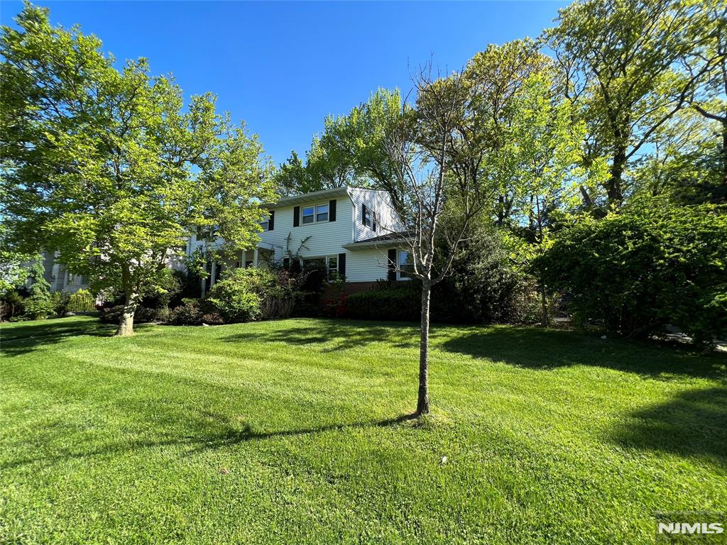 Welcome to this beautiful, light-filled Center Hall Colonial in the prestigious North Cliffs of Englewood Cliffs, one the area's most desirable neighborhoods. This approx. 2800 SQFT house offers 5 bedrooms and 2.1 bathrooms. Large entrance hall leads to a big living room, dining room & family room all beautifully detailed w/ moldings & paneling. The kitchen is large & bright w/ 2 skylights over the middle island, granite countertops & custom made cabinets & top stainless steel applcs. A bedrm/office, laundry & powder room complete the 1st floor. On the 2nd floor, there is a spacious master suite w/ 2 closets, 3 add'l bedrooms & an updated full bath. The full & finished basement for entertainment. Nice landscaping with sprinklers system. Hardwood floor thru-out. 2-car garage and possible 5-6 driveway parking spaces.