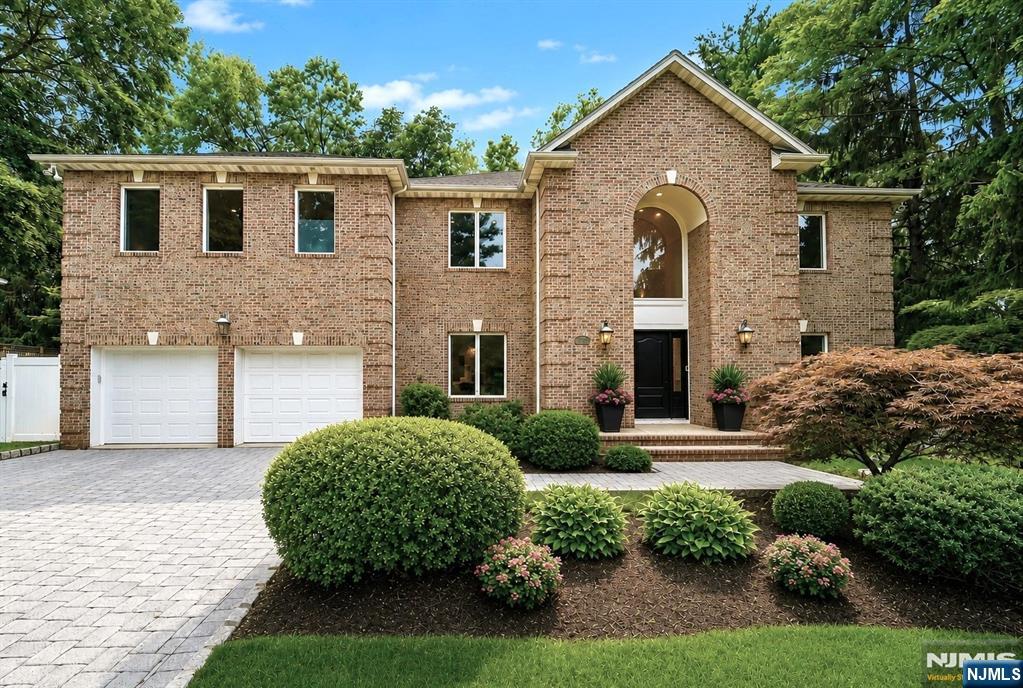 Discover timeless design and architectural elegance in this exceptional all-brick Colonial, situated on the prestigious East Hill of Closter. Thoughtfully and extensively remodeled within the past year, this luxurious residence showcases impeccable craftsmanship and sophisticated finishes throughout three levels of refined living space. Offering 6 spacious bedrooms and 5.5 updated baths, this DiStaulo-built home is designed for both everyday living and grand-scale entertaining. A vaulted foyer with marble flooring, a grand staircase, and cascading chandelier sets an impressive tone upon arrival. Bright interiors highlight exquisite millwork, designer fixtures, and meticulous attention to detail. The gourmet kitchen is a true masterpiece, featuring an oversized center island, premium appliances with integrated paneling, and an open-concept that flows effortlessly into gathering spaces. Upstairs, the expansive primary suite with sitting area offers a private retreat with a spa-inspired bath, soaking tub overlooking treetop views, and dual walk-in closets. Two additional bedrooms with a connecting bath, junior en-suite and a convenient laundry room provide the ideal layout. The recently finished lower level adds another bedroom and full bath, along with generous recreation space. Uniquely reimagined with an upscale quality rarely found in Bergen County, this extraordinary residence is located in a coveted neighborhood with top-rated schools, a vibrant downtown and access to NYC.