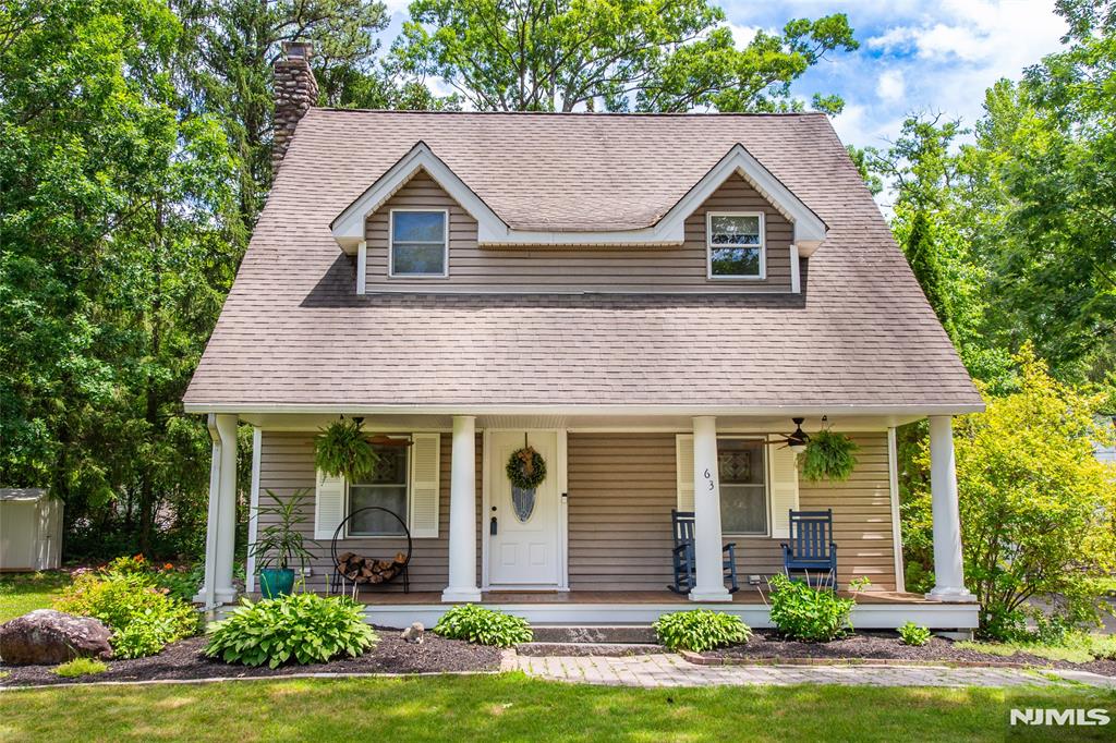 Located in the desirable Awosting community of Greenwood Lake, this beautifully maintained 4-bedroom, 2.5-bath Colonial offers the perfect blend of charm, comfort, and lake living. A spacious covered front porch with mahogany wood flooring and ceiling fans welcomes you home and sets the tone for the relaxed lifestyle this property offers. Inside, the sun-filled layout features a cozy family room with a wood-burning stove, a bright living room with a wood-burning fireplace, and a charming kitchen with breakfast nook flowing into a generously sized dining room, ideal for everyday living and entertaining. The main level also includes a laundry room and stylish powder room with barn doors. Upstairs you'll find four spacious bedrooms, including a primary suite with private bath and walk-in closet, plus an updated full hall bath. Outside, enjoy a paver patio, private backyard, detached 1-car garage, generator hook-up, and public water/sewer. Inside includes a central vacuum unit, central air and a brand new high efficiency furnace. Enjoy all that this private lake community has to offer: a private beach, two private boat launches, kayaking, fishing, swimming, tennis courts, basketball courts, playground, clubhouse, and year-round community events. This is not just a home, it's your new lifestyle.