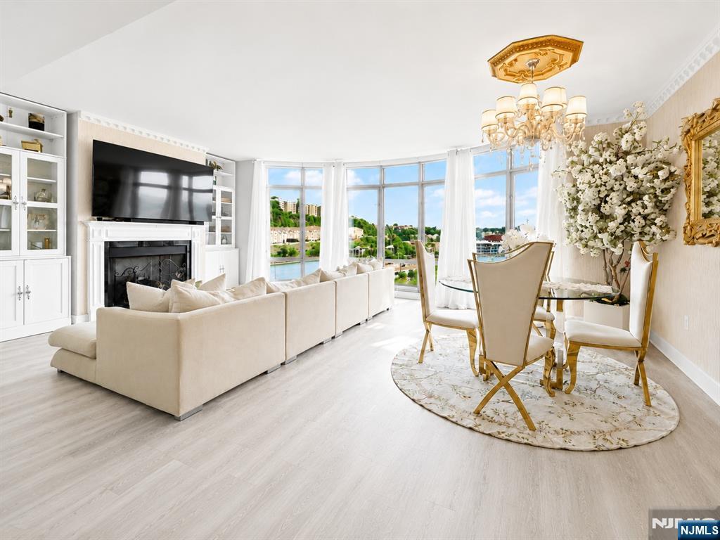 Experience elevated waterfront living in this expansive 2-bedroom, 2-bath residence at The Watermark, one of the Gold Coastâ€™s premier luxury buildings. Spanning 1,535 square feet, this beautifully appointed home features a thoughtfully designed layout, upscale finishes, and sweeping views of the Hudson River and George Washington Bridge. The chef-inspired kitchen opens seamlessly to the living and dining areas, creating an ideal space for everyday living and entertaining against a dramatic waterfront backdrop. The spacious primary suite offers two closets and a marble, spa-like bath, while the generously sized second bedroom and full bath provide comfort and flexibility for guests, a home office, or additional living space. In-unit laundry and 2 car garage parking add everyday convenience. Residents enjoy approximately 40,000 square feet of amenities, including 24-hour concierge, doorman and valet service, indoor and outdoor pools, barbecue areas, a full health club with sauna, steam room, and massage room, screening room, golf simulator, library, childrenâ€™s playroom, business center, resident lounge, and guest suites. A private shuttle provides convenient access to the ferry, with NYC bus service located directly at the entrance. A rare opportunity to enjoy space, service, views, and resort-style amenities in one exceptional waterfront residence.