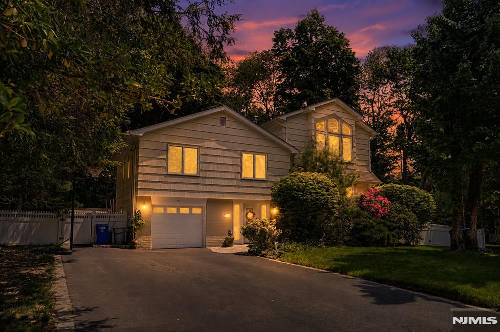 Welcome to this beautifully expanded 2,400sq. ft. Sugar Maple split-level home located on a quiet, private street in the heart of Park Ridge. This sun-filled south-facing residence offers 4 spacious bedrooms and 3.5 updated bathrooms with comfort, style, and functionality throughout. Step inside through the bright foyer leading to an inviting family room complete with a half bath and laundry area. Hardwood floors flow throughout the home, while central AC and hot air provide year-round comfort. The newly renovated eat-in kitchen features quartz countertops, stainless steel appliances, skylights, and abundant natural light, with direct access to a large deck overlooking the expansive backyard â€” perfect for entertaining or relaxing outdoors. The main living area offers an open-concept living room with a fireplace and formal dining room with bay windows. The fully finished basement provides additional living and entertainment space. Upstairs youâ€™ll find the first of two primary bedroom suites with an updated en-suite bathroom, along with two additional bedrooms and another updated full bath. The top level is dedicated to a stunning custom primary retreat boasting soaring vaulted ceilings, bay windows, a spa-like en-suite bathroom with jacuzzi tub, and a spacious walk-in closet. Conveniently located just minutes from the Garden State Parkway, shopping, dining, parks, and top-rated schools, this exceptional home offers the perfect blend of space, privacy, and modern updates.
