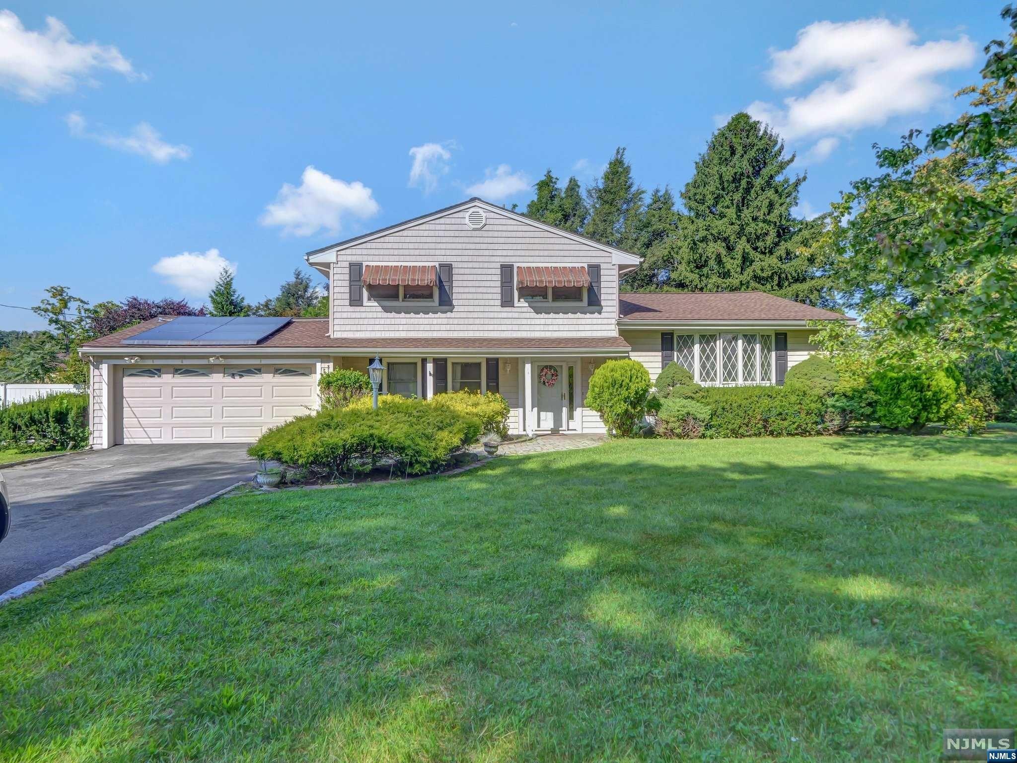 Charming 4-bedroom, 2.5-bathroom split-level home on a quiet cul-de-sac. The inviting foyer leads to a spacious family room with a wood-burning fireplace, adjacent versatile bedroom, powder room, laundry, and garage access. The first floor features an open-concept layout with a light-filled living room, custom windows, and a dining room flowing into a bright kitchen with custom cabinetry, marble countertops, backsplash, and stainless steel appliances. Upstairs, the primary bedroom offers hardwood floors, a large closet, and an en suite with a glass-enclosed shower. Two additional bedrooms and a tub/shower complete the second floor. Sliding glass doors lead to a private backyard retreat with a paver patio and in-ground pool. Additional amenities include an unfinished basement and a 2-car garage. This home offers spacious living with modern amenities, perfect for comfortable living and entertaining.