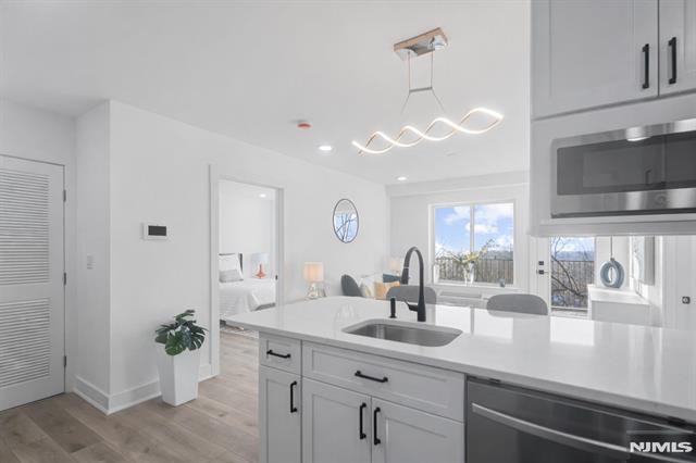 TRUE 2 BEDROOM condo with 2 FULL BATHS and PRIVATE TERRACE in a NEW CONSTRUCTION elevator building with SWEEPING MEADOWLANDS VIEWS and ABUNDANT NATURAL LIGHT. Meadowview Residences is a boutique 12-unit building perched high with OPEN EXPOSURES ON ALL SIDES. This bright home features OPEN-CONCEPT LIVING, MODERN KITCHEN, and IN-UNIT LAUNDRY. Convenient access to PUBLIC TRANSPORTATION TO MANHATTAN. Premium indoor GARAGE PARKING with easy maneuverability available.