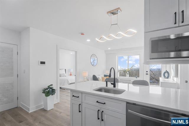 TRUE 2 BEDROOM condo with 2 FULL BATHS and PRIVATE TERRACE in a NEW CONSTRUCTION elevator building with SWEEPING MEADOWLANDS VIEWS and ABUNDANT NATURAL LIGHT. Meadowview Residences is a boutique 12-unit building perched high with OPEN EXPOSURES ON ALL SIDES. This bright home features OPEN-CONCEPT LIVING, MODERN KITCHEN, and IN-UNIT LAUNDRY. Convenient access to PUBLIC TRANSPORTATION TO MANHATTAN. Premium indoor GARAGE PARKING with easy maneuverability available.