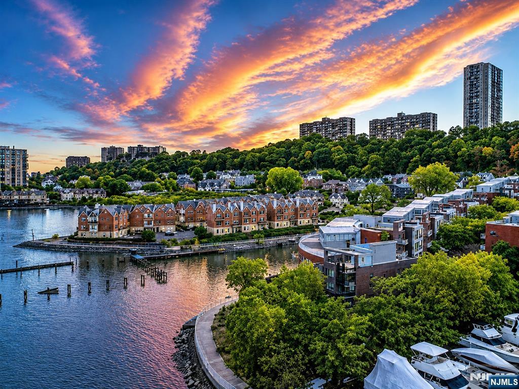 THE 2ND LARGEST MODEL IN THE COMPLEX! SPECTACULAR MULTI-LEVEL TOWNHOME LOCATED ON EDGEWATER'S GOLD COAST!! APPROX. 4200 SF WITH AN OPEN FLOOR PLAN AND A FULL BASEMENT BONUS LEVEL-NOT INCLUDED IN THE SF. OFFERING A ROOFTOP DECK INCLUDING WATER, ELECTRIC, GAS FOR ALL YOUR GRILLING NEEDS AND AN ENCLOSED GLASS SOLARIUM. A PRIVATE FULL-SIZE ELEVATOR, BRIGHT ROOMS WITH FLOOR TO CEILING WINDOWS, HARDWOOD FLOORS AND RADIANT HEAT THROUGHOUT, CENTRAL VACUUM, 2 STEAM SHOWERS, 2 JACUZZI TUBS, STATE-OF THE ART KITCHEN WITH SUB-ZERO REFRIGERATOR AND GRANITE COUNTER TOPS, 4 BEDROOMS, 4.5 BATHROOMS, MULTI-BALCONIES, PRIVATE 2 CAR GARAGE-PLUS 2 DRIVEWAY SPACES. OFFERING LUXURY LIVING AT IT'S BEST! BEAUTIFUL NORTH, SOUTH, EAST RIVER AND NYC VIEWS. STEPS TO A BEAUTIFUL POOL THAT LOOKS OUT TO THE MANHATTAN SKYLINE. NEXT TO A MARINA'S FOR ALL YOUR BOATING NEEDS. MINUTES TO THE EDGEWATER/NYC FERRY & GW-BRIDGE, VERY CLOSE TO SHOPPING, TRANSPORTATION & RESTAURANTS! IT'S AN ABSOLUTELY BREATHTAKING UNIT! COME PREVIEW!