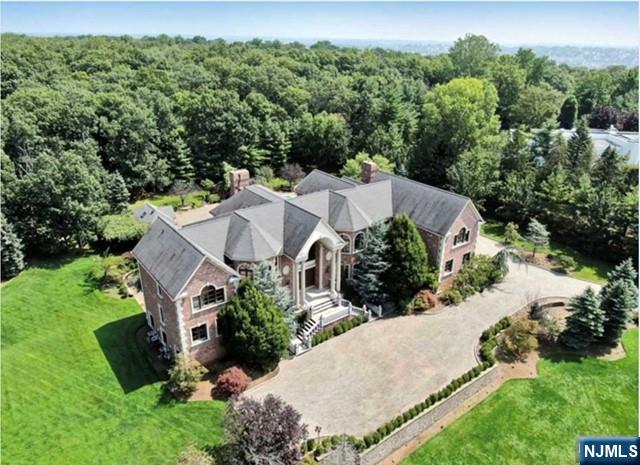 Luxury and elegance collide at this exceptional custom built 2-acre gated estate. The attention to detail is obvious the moment one walks through the door.Soaring ceilings complimented with custom crown molding and extensive hand painted wall art exude a feeling of classic elegance.The stunning brick colonial features 6 bedrooms, 7 bathrooms/2 powder rooms and lush Italian windows and doors throughout.The gourmet kitchen boasts 2 full-size Viking refrigerators, 2 Miele dishwashers a professional Viking stove, wine refrigerator and ice maker. Entertaining is at its height, with a gracious formal dining room, music room as well as a full bar adjacent to the stately living room. A paneled library is accented with stunning built-ins, where French doors access the backyard private oasis with heated pool and cabana, featuring a kitchen and full bath. Ample Parking! Reward school. Minutes from Manhattan.