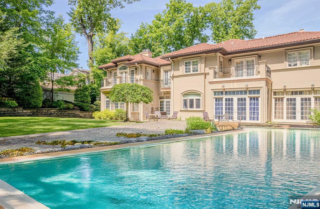 Introducing your home in the heart of Tenafly! Located in a prestigious area known for its excellent schools, vibrant community, and convenient access to NYC, this property offers a luxurious and comfortable lifestyle. This 7-bedroom, 6-bathroom colonial mansion epitomizes luxury and elegance, blending classic charm with modern flair. The home boasts generously sized bedrooms and bathrooms, providing ample space for family, guests. The heart of the home features a gourmet kitchen, ideal for culinary enthusiasts and entertaining. A dedicated private office provides a quiet retreat for work or study. The finished basement offers additional living space, perfect for a home theater, gym, or recreation room. Enjoy summer days by the pristine swimming pool, surrounded by landscaped trees for privacy. The three-car garage offers ample space for vehicles and storage. Schedule a private showing today and experience the best of Tenafly living!