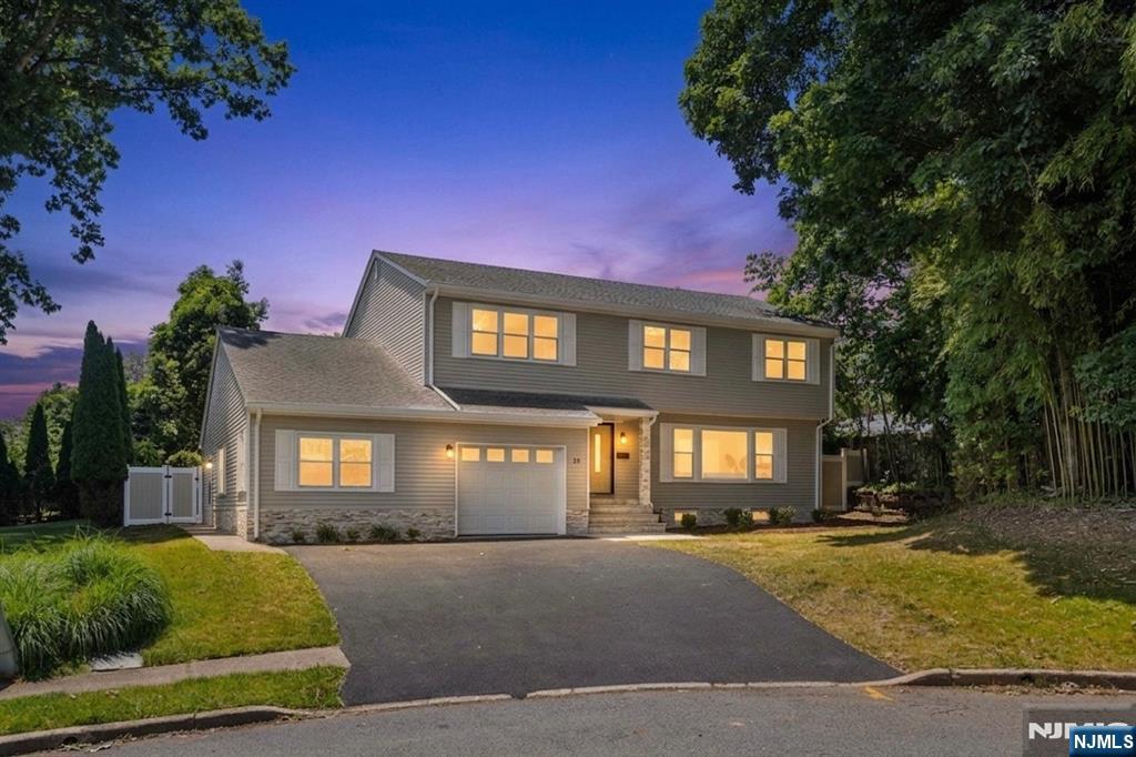 Completely renovated and move-in ready, this home blends timeless style with modern updates throughout. Sun-filled interiors feature hardwood floors, updated lighting, and an inviting layout ideal for everyday living and entertaining. The kitchen showcases custom cabinetry, quartz countertops, premium Forno appliances, a farmhouse sink, tile backsplash, and generous workspace. Living and dining areas flow seamlessly into the family room featuring a custom wet bar with beverage refrigerators and direct backyard access. A spacious in-law suite with a private entrance offers flexibility for extended family, guests, or multi-generational living. Upstairs, the spacious primary suite features a walk-in closet and updated bath. Additional bedrooms are complemented by renovated bathrooms with designer tile and custom vanities. The finished lower level offers recreation, office, gym, or play space and includes a dedicated laundry area. Set on a private cul-de-sac with patio space for outdoor enjoyment, this home offers the perfect blend of comfort and functionality. Enjoy Emerson's excellent schools, parks, local shops and restaurants, NJ Transit service, and convenient access to major highways. A rare opportunity to own a turnkey home in one of Bergen County's most desirable communities.