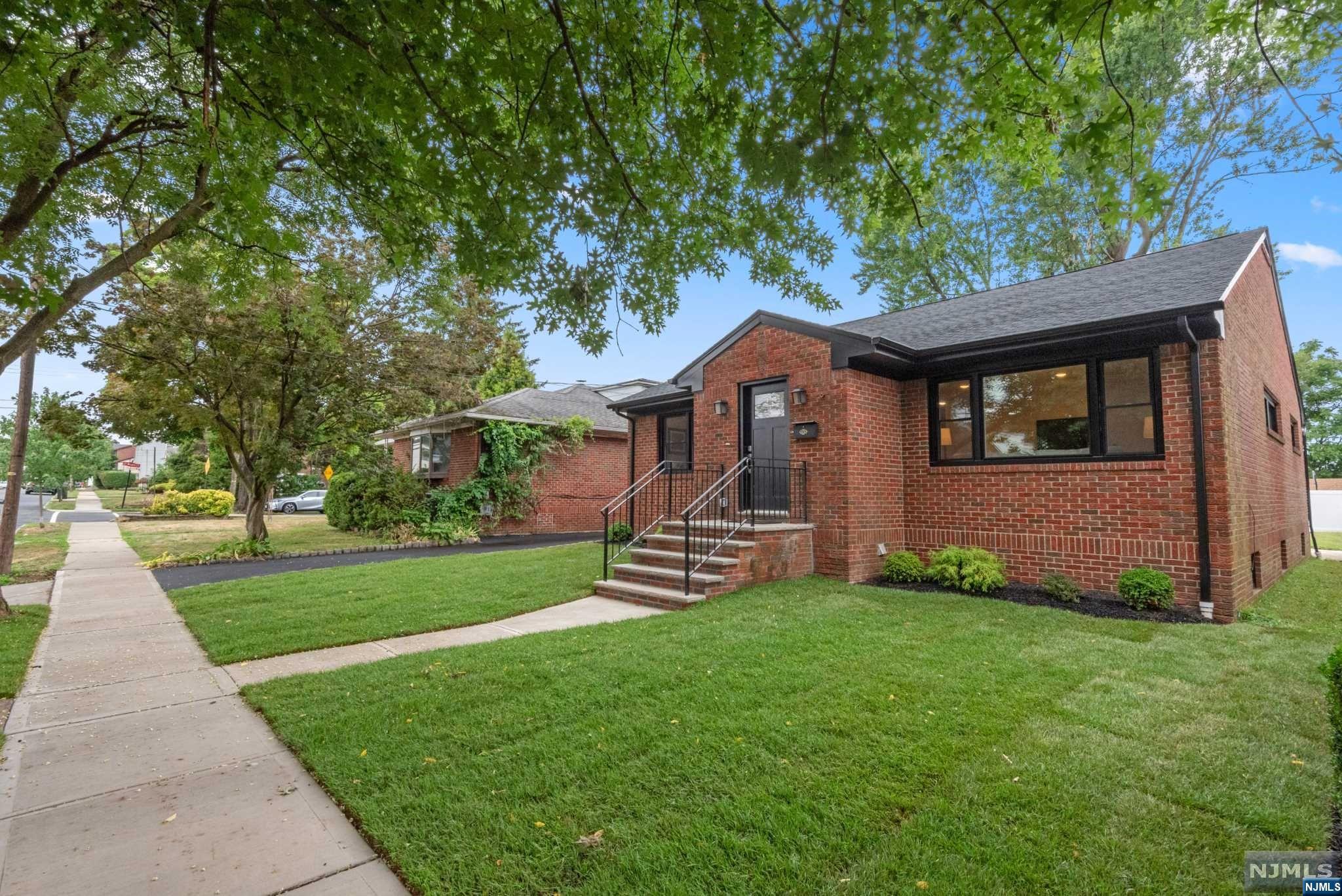 Newly rebuilt designer brick ranch w/stunning & spacious first & lower levels. Step into the inviting foyer & sun-filled L/R where natural light creates a welcoming atmosphere. The spectacular kitchen, perfect for culinary enthusiasts, ensuring delightful dining experience, while enjoying views of the outdoors. The kitchen boasts high-end finishes, including chic backsplash, s/s appl's, custom cabinetry, quartz counters & center island. Enjoy convenient access to the yard through the adjacent sunroom, where you can unwind w/a glass of wine. The wonderful primary B/R features a new ensuite. 2 spacious B/R & main bath complete the 1st floor. Thoughtful modern updates on this main floor include walnut H/W flrs, black frame windows & recessed lights. The stunning lower level showcases the best in quality craftsmanship w/high ceiling, porcelain tiles & spaces for Family Rm, Home Office, Powder Rm, potential 4th B/R, laundry & outdoor access. Walk to train /NYC trans. Worry free living!