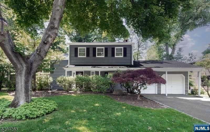 CURB APPEAL and TRANQUILITY abounds. Situated on a LEVEL LOT in desirable CHERRY HILL is this one owner, well maintained and updated 4 BEDROOM 2.5BATH Split-Level style home waiting for you this summer. A covered welcoming entry opens to Foyer w warm HARDWOOD FLOORS throughout. Expanded Family Room with WB Fireplace (Chimney and FP conveyed as-is), built in cabinetry, shelving, large sliders to yard and interior access to the roomy 2 car garage. Family Room has been enlarged to encompass Bedroom 4. Can easily be easily be converted back to 4th Bedroom. The sunny Eat in Kitchen features a great layout with quality wood cabinetry and sliding doors for easy access to backyard patio for all your entertaining. The formal Dining Room can seat all your guests. Convenient Powder Room (easily expanded to full bath) completes the Grade Entry floor (NO STEPS). Sizeable formal Living Room boasts Picture Window to let the light filter in. Upper Level finds a generous Primary Bedroom