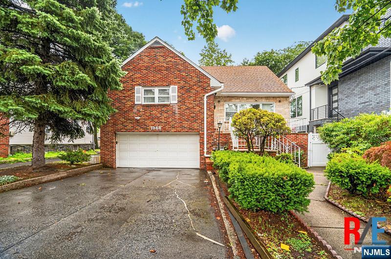 Beautifully updated brick home on a 50x110 lot size in one of Bergen Countyâ€™s most sought-after communities! This sun-filled residence features hardwood floors throughout the main level, recessed lighting, and an open-concept layout ideal for everyday living and entertaining , the spacious living room flows into the formal dining room and updated kitchen, complete with maple cabinetry and stainless steel appliances. Just off the kitchen is an enclosed sunroom with direct access to the backyard, . The main level also offers three generously sized bedrooms, two full bathrooms, and the convenience of a laundry area on the same floor. The finished upper level provides excellent bonus space with endless possibilities, including a home office, playroom, or additional living area. The finished walk-out lower level features high ceilings, a full bathroom, laundry area, and flexible living space ideal for a recreation room, home gym, or extended living. Completing the home is an attached two-car garage plus two additional outdoor parking spaces. Additional features are 2 zones heater and central AC. Ideally located within walking distance to School No. 4, parks, shopping, restaurants, NYC transportation.