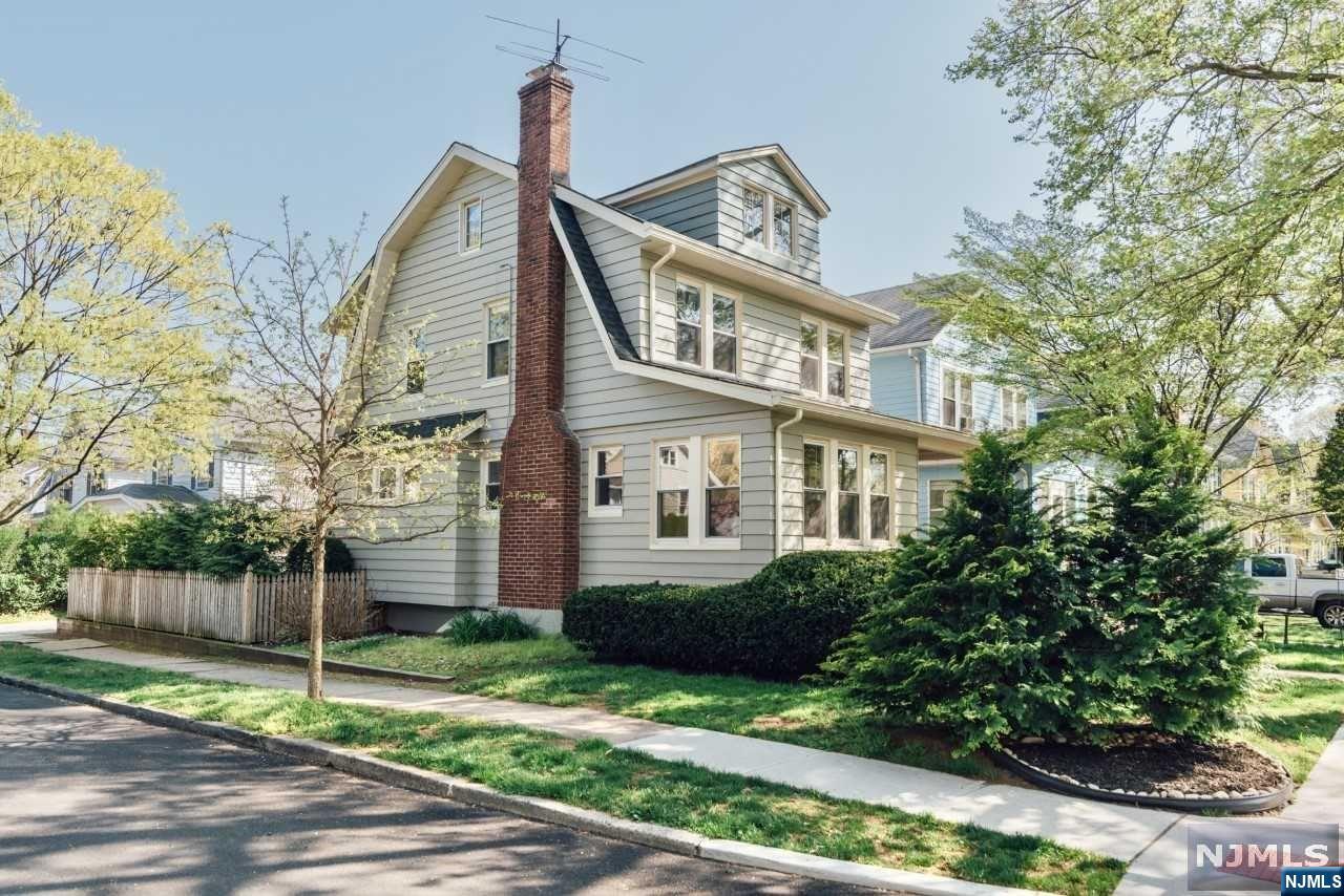 This Classic Glen Ridge home is located on a quiet corner lot of tree lined Midland Avenue and offers FOUR bedrooms, TWO baths and a TWO car garage. Upon arriving at the welcoming front porch, you enter the first floor with a sun filled living room with pre-war details, hard wood floors and tall ceiling height, anchored by a wood burning fireplace. A charming sunroom faces the front of the property while the formal dining room flows to the side of the home, with the kitchen facing the back yard, which is landscaped and perfect for entertaining. The fully renovated basement features a den, full bath and laundry room, as well as an office space and pantry. Rising to the second floor you will find a spacious full bath with heated floor, and three bedrooms, each with its own closet and big windows that let in the light and view of wonderful mature trees. Rise again to the third level and you are greeted with an expansive loft space, featuring FOUR exposures, new windows and floors.