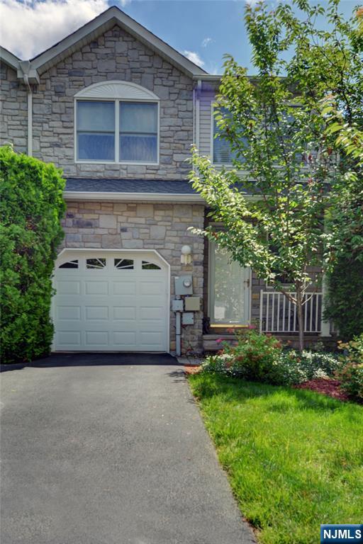 Welcome to the Tulip Model. Move right in and start enjoying this beautifully maintained townhome! Enter into a dramatic two-story foyer that leads to a spacious living room featuring a wood-burning fireplace and a glass door that opens to a private deck with serene backyard views. The living room flows seamlessly into a freshly painted, updated kitchen. Upstairs offers a generous primary suite with a walk-in closet and an en-suite bath with a jetted tub. A second bedroom also features a walk-in closet and a full bath with a shower. Additional highlights include a large unfinished basement, one-car garage, and convenient access to the train station and Routes 10, 287, and 80.