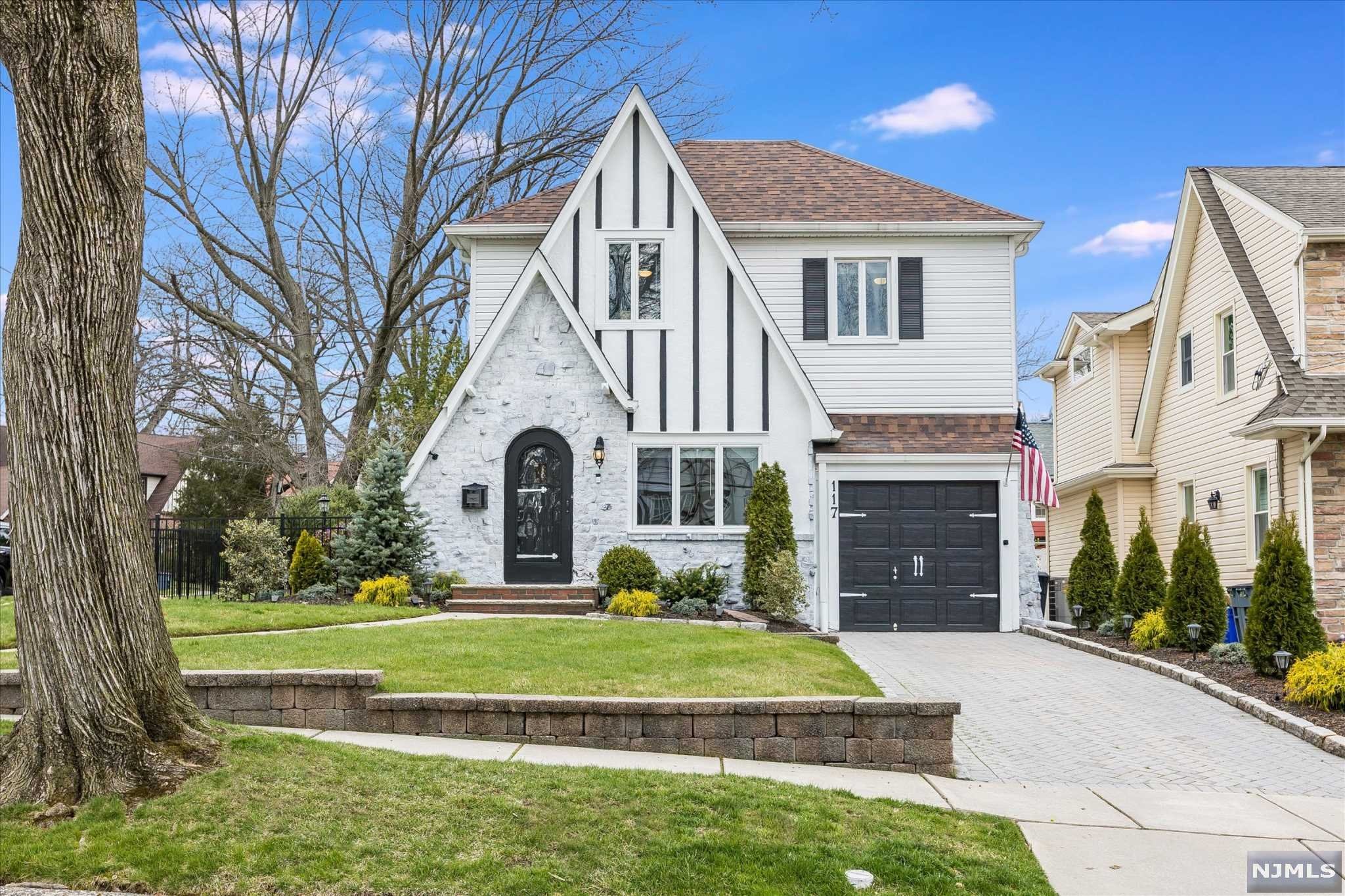 Storybook Tudor sits upon a corner lot in on quiet, tree lined street in Nutley, NJ. The curb appeal is mirrored on the inside of this home with several recent interior upgrades. Charming entry way leads into living room with a clear view into the rest of the first floor open layout. Bright & modern kitchen has high end appliances and center island perfect for entertaining, as it is adjacent to both dining room and family room. High ceilings, gas fire place and sliding doors to exterior patio make this a versatile space for all living styles. Powder room completes first floor. Second floor boasts three well-sized bedrooms with great closet space. Large main bath has built in tub and stall shower. Finished basement could be rec room, office, or playroom with a full laundry and bath. Exterior of home has private backyard paver patio and fenced in back and side yard. Located near Nutley's park system, school, public transportation to NYC, shopping and ON3 campus. Come start your new
