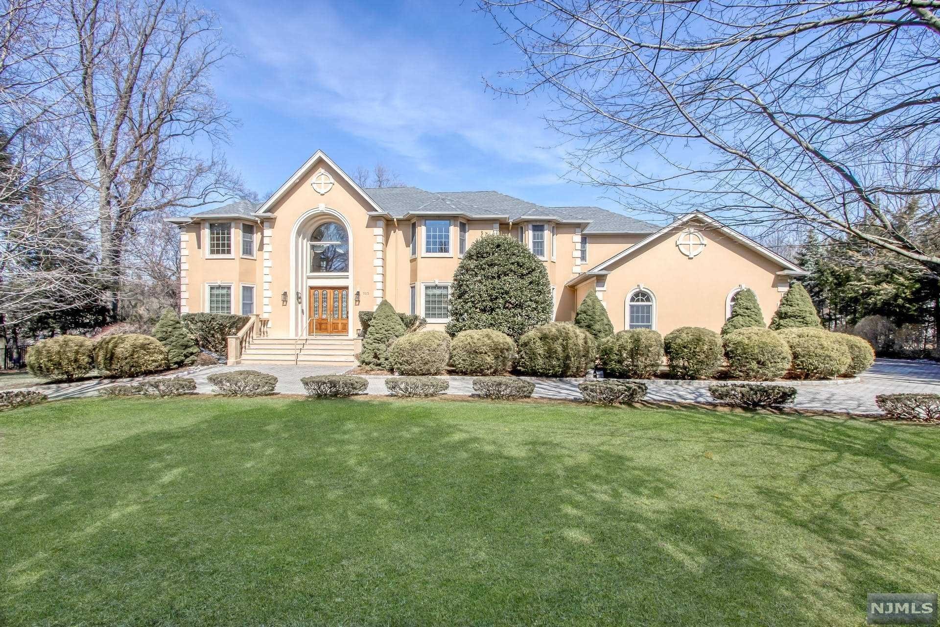 Expansive 8-BR Colonial on close to an acre in Cresskill. Two-story entry with soaring ceiling and winding staircase. Large living room with French doors to spacious office. Bright, open great room including fireplace, wet bar and doors to deck. Gourmet kitchen is complete with granite countertops, custom cabinets, large center island, walk-in pantry, stainless appliances and built-in desk. Banquet-sized dining room. Two spacious bedrooms, full bath, laundry rm and half bath. 2nd level offers luxurious primary ste including fireplace, balcony, dressing room, walk-in-closets, and primary bath with separate shower and tub. Large bedroom with French doors and balcony. Spacious Junior suite including updated full bath. Two additional guest rooms and an updated full bath completes this level. Finished walk-out lower level offers with recreation room, den with fireplace, 2 bonus rooms, bedroom, theater room, gym, full bath and half bath. Lush property with fenced-in backyard and deck.