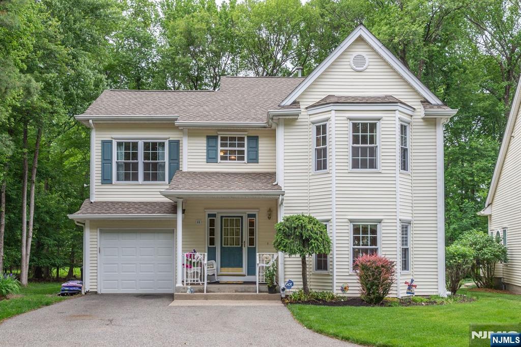 Rare opportunity to own a single-family home in the highly sought-after community of The Glens! This beautifully maintained 4-bedroom, 2.5-bath Colonial offers the perfect blend of space, comfort, and community amenities. Step into the impressive two-story entry foyer and immediately appreciate the home's bright, open layout. The formal LR is filled with natural light and flows seamlessly into the elegant DR. The heart of the home is the newly renovated kitchen, featuring custom gray cabinetry, crisp white quartz countertops and a center island. The kitchen opens to a dramatic family room with skylit vaulted ceilings and a cozy gas fireplace. The back door from kitchen leads to a spacious deck complete with a powered custom awning, creating the perfect outdoor retreat. Powder room and garage access complete the first floor. Upstairs, are 3 generously sized secondary bedrooms, an updated hall bath, and a linen closet. Double doors lead to the primary suite featuring a WIC and ensuite bath with dual vanities, glass-enclosed shower, and jetted tub. The finished LL offers flexibility with space for recreation, a home office, gym, and storage. Laundry is currently located in the LL, with additional first-floor hookups. Enjoy the best of both worlds: the privacy and space of a SFH paired with the amenities of The Glens, including pools, clubhouse, tennis courts, and playgrounds. Located near shopping, walking trails, highways, and within a highly rated Pequannock School District.
