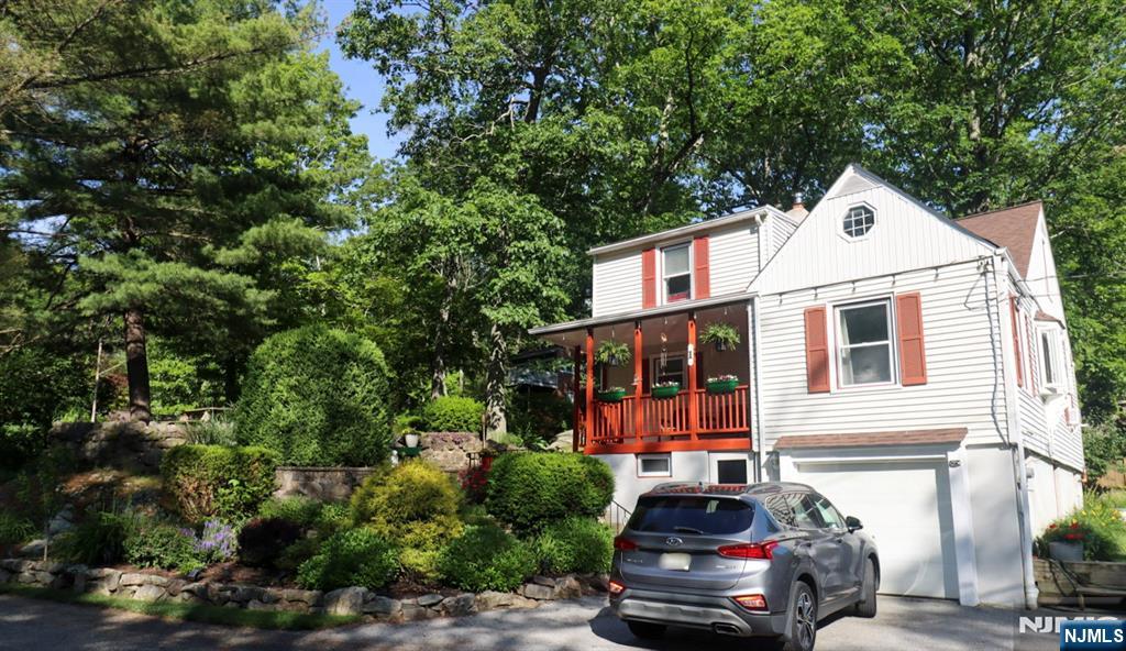 Charming custom-built Cape Cod home nestled on a prime corner lot, offering stunning lake views of Lake Hopatcong. Just steps from the private Knollwood Club beach, with annual dues of only $150 additional boat slip available for $100. What a great way to have access! This delightful home features 3 spacious bedrooms plus a dedicated office, perfect for working remotely, and 1.5 bathrooms. The open floor plan seamlessly connects the living room and dining area to an inviting office with elegant glass French doors. If you don't need an office you can consider it a dining room.Recent updates include fresh interior paint, furnace, chimney sleeve, Roth oil tank, and a bay window all completed within the last few years. Roof was done in 2019 and has a 50 year roof with a transferrable warranty to the next owner. Beautifully landscaped with mature plantings, the property offers privacy and curb appeal. The attached one-car garage provides convenient parking and storage. Don't miss this one!