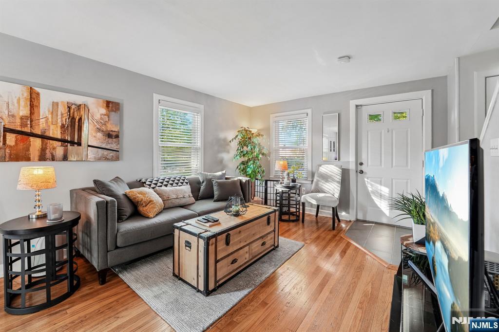 This bright and updated end-unit townhouse offers a comfortable, low-maintenance layout in a prime location. The first floor features a spacious living and dining area with hardwood floors, connecting to a kitchen finished with quartz countertops. The second level holds two bedrooms and a full bathroom, with extra storage easily accessed via a pull-down attic staircase. The home has been updated with a new water heater (2024), central air (2023), windows (2022), dish washer (2022), furnace (2020), and an in-unit washer and dryer (2019). Outside, the front door opens toward a yard space, while the back door leads to a patio. The property includes one assigned parking space, guest parking, and an extra storage unit in the common basement. Perfectly situated for commuting and leisure, it sits just steps from a direct bus to New York City and downtown Englewood, featuring upscale dining, the Bergen PAC, local parks, and houses of worship. Pets are welcome! Come see the possibilities your personal touches can make!