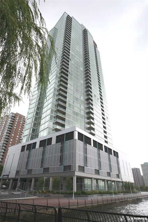 Experience luxurious waterfront living at its finest in this spacious 1-bedroom, 1.5-bath unit at Crystal Point Condominium which offers breathtaking direct East-facing views of the NYC skyline and Hudson River from its 1,050 sq. ft. of elegant living space. This home features an open floor plan, Hunter Douglas blinds and gleaming hardwood floors throughout. Top of the line kitchen with high-end appliances, Italian cabinetry & quartz countertops. The spacious bedroom comes with a walk-in closet. It also has a Bosh washer/dryer in-unit and central air. The amenity rich building offers 24/7 concierge, gym, swimming pool, sauna steam, jacuzzi, outdoor BBQ, children's play room and theater. Close to Newport/Exchange Place PATH, Ferry and Light Trail. 1 valet parking is included.