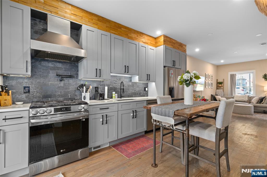 Extremely rare! This stunning single family home in Union City spans 4 levels & has been fully renovated to perfection. Featuring 4 beds, 2 full & 2 half baths, every inch of this home exudes modern elegance. The gorgeous kitchen & bathrooms showcase impeccable craftsmanship, w/ sleek finishes & heated bathroom floors. The multi-zone central air system ensures year-round comfort w/ energy savings, while recessed & accent lighting add warmth to every space. Beautiful hardwood floors flow seamlessly throughout, while tall ceilings enhance the open & airy feel. Step outside to an amazing backyard oasis w/ a patio & lounge area, perfect for entertaining. Plus, enjoy 2 deeded parking spots, a rarity in this area! The basement is a dream space ready to be transformed into whatever you desire. The location is unbeatable w/ NYC buses at your doorstep & easy access to the Light Rail, PATH & Lincoln Tunnel. Homes like this do not come around often. Priced to sell, do not miss it!