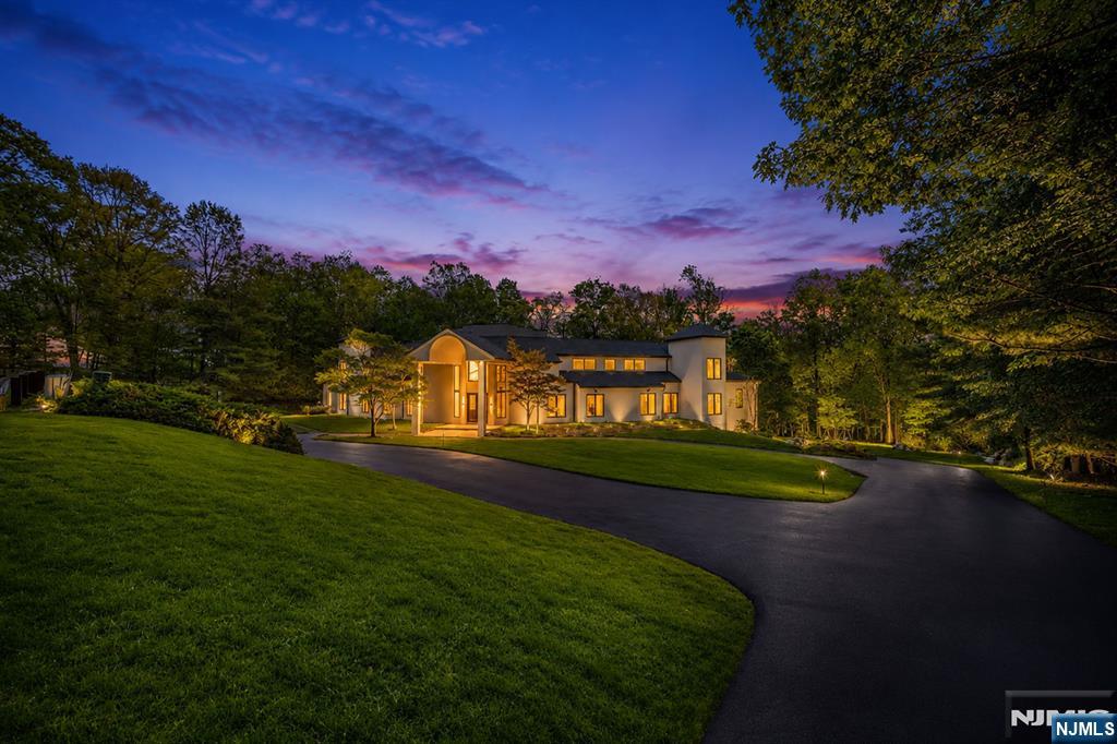 Introducing 809 W. Shore Road, a fully renovated, approximately 9,000-square-foot residence in Smoke Rise, offering refined lake living with modern construction and design. This six-bedroom, six-and-a-half-bath home was completely reimagined by JLA Interiors and built by Peak Developers, combining thoughtful planning with quality craftsmanship. A 20-foot great room forms the center of the home, with expansive windows that frame serene lake views and bring in abundant natural light. Stucco exterior finishes lend a clean, contemporary profile that complements the setting. The oversized kitchen is designed for both everyday use and entertaining, with generous workspace, storage, and direct connection to the main living areas and outdoor spaces. The layout supports a natural flow from cooking and dining to relaxation by the pool or in the great room. The primary suite functions as a private retreat, featuring two large walk-in closets and a spa-like bathroom with a carefully considered layout and finishes. Each additional bedroom is paired with access to well-appointed baths, providing comfort and convenience throughout the home. Outdoor living is a key highlight, with a pool that overlooks the lake, creating a strong indoor-outdoor connection and an ideal setting for seasonal enjoyment.