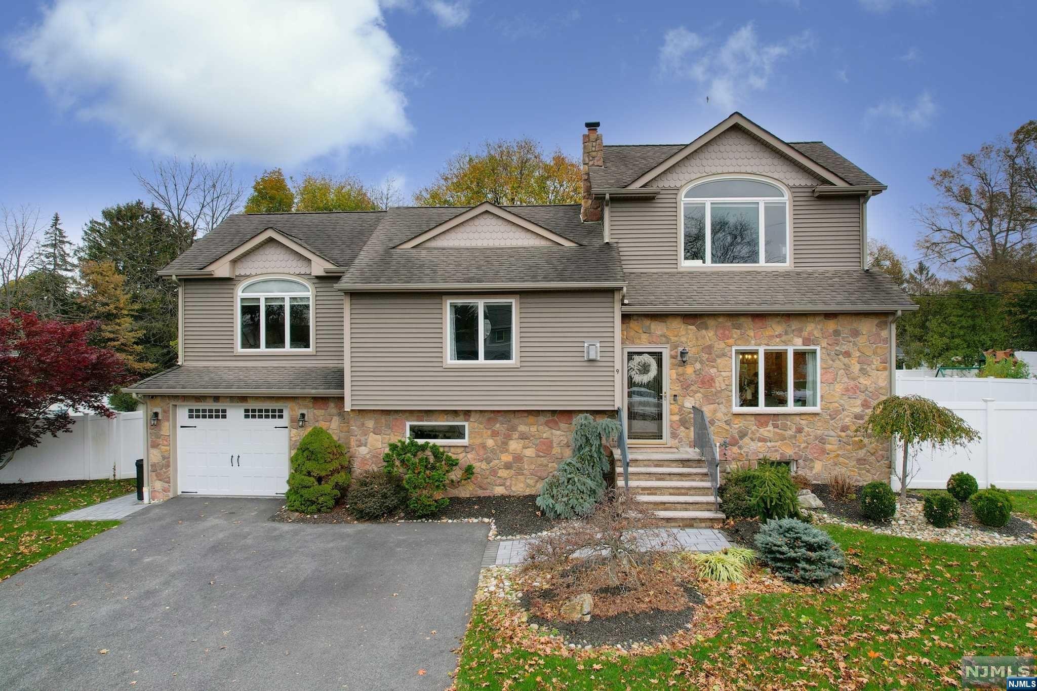 Welcome to this pristine four bedroom expanded split level home in desirable Wayne! Enter into the living, dining room with brand new white oak hardwood floors and open concept with easy flow into the stunning updated kitchen. The kitchen has top of the line, stainless steel appliances, gleaming quartz countertops and an expansive island. Sliding glass doors lead you to the trex deck with a hot tub overlooking the pristine back yard that includes a paver patio with a fire-pit and built in seating. Upstairs, three large bedrooms and a beautifully updated full bathroom. On the third floor the primary bedroom with double closets and gorgeous full bath with double vanity. On the ground floor, access from the garage with epoxy flooring and the family room with a gas fire place, a full bath and access to the back yard. The finished basement allows for extra living space, a laundry room and plenty of storage!