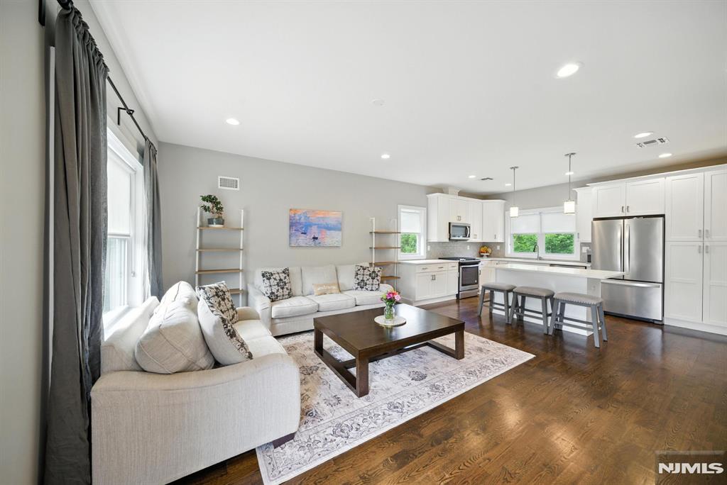 Welcome to the Brownstones at Fairfield! Built in 2018, this 3-level end-unit townhome offers modern living with hardwood floors, energy-efficient windows/doors, tankless hot water heater, and multi-zone heating/cooling. The first level features a foyer, garage entry, laundry room, storage, and backyard access. The open-concept second level offers a white shaker kitchen with quartz counters, center island, pantry, living room, powder room, and balcony. The third level features 2 ensuite bedrooms. The primary suite includes double closets with custom built-ins and a luxury bath with oversized tile shower and quartz vanity. The second ensuite offers a full bath and a closet. Top Rated Schools. Minutes to NYC transit, shopping, and major highways. Not in a flood zone.