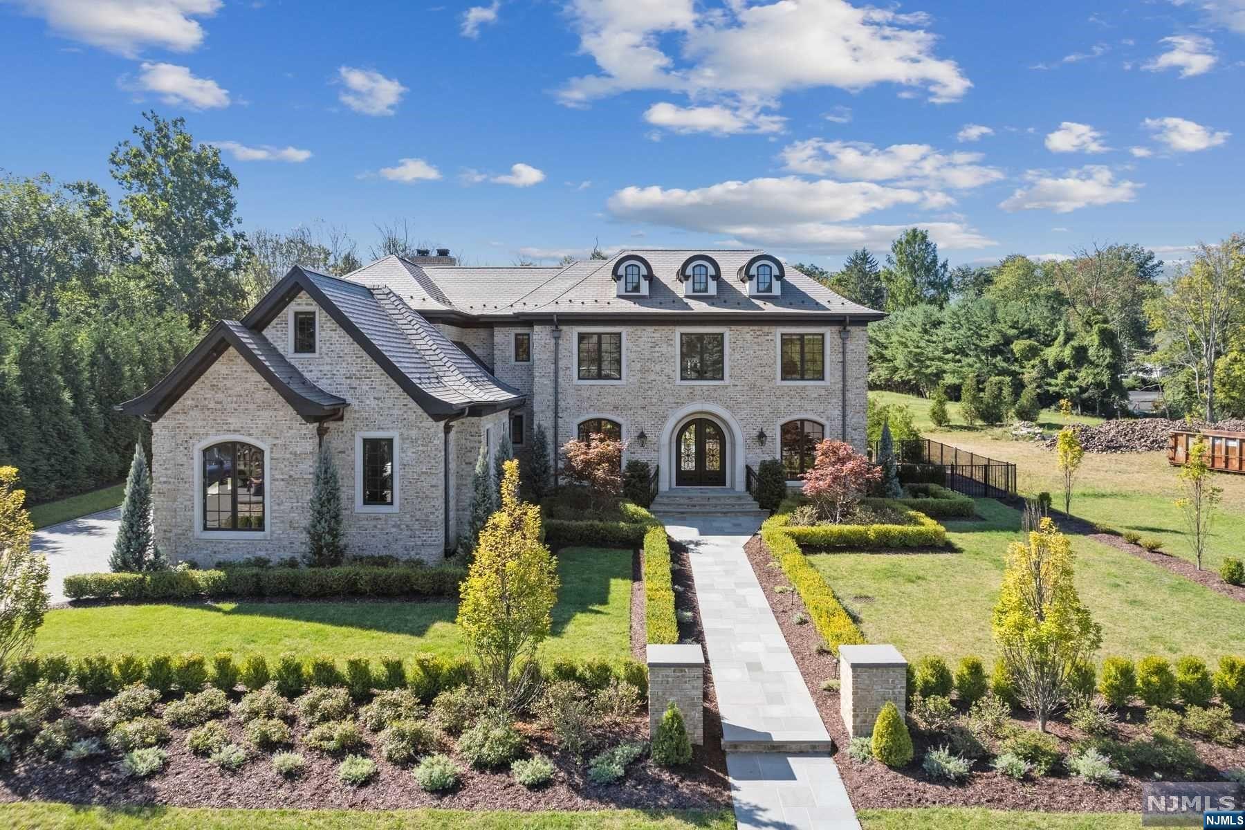 A Magnificent Estate located on one of the most desired streets in North Caldwell. This extraordinary home has over 7,400sq ft of finished living space. Superior Craftsmanship w/Impressive Artisan Custom Detailed Moldings, 9ft Ceilings, White Oak HW Floors, Arched Doorways & Floor to Ceiling Palladian Windows throughout. Welcomed into the Grand Foyer w/ 23ft Ceilings, a Formal Living Rm w/Gas Fireplace, Formal Dining Rm w/Butlers Pantry, & 1st Floor Guest Suite/Office w/Full Bath. Gourmet Kitchen w/Prof Grade Appliances including Sub Zero & Wolf, Custom Inlay Cabinetry w/Lead Glass Inserts, Quartzite Counters, Oversized Center Island, Separate eating area w/French Doors leading to Outdoor Living. Soaring 2 Story Family Room w/Fireplace & Incredible Coffered Ceilings. Sun Drenched Great Room w/ Wood Burning Fireplace & Vaulted Beamed Ceilings. Powder Room, Mudroom, Laundry & access to 3 Car Oversized Garage complete 1st Floor.
