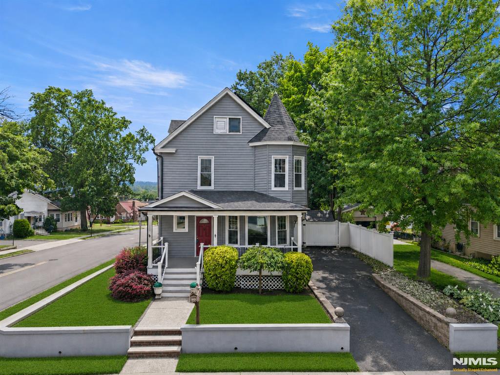 Welcome to this spacious and charming Colonial ideally situated on a desirable corner lot in a convenient location close to the train, town pool, parks, shopping, downtown amenities, and more. A welcoming covered front porch sets the tone and provides the perfect place to relax and enjoy the neighborhood. Inside, you'll find a bright and inviting main level featuring a generously sized living room, formal dining room, eat-in kitchen, and convenient half bath. Hardwood floors, high ceilings, and abundant windows fill the home with natural light while enhancing its classic character and warmth. The second floor offers three well-proportioned bedrooms and a spacious full bath. Additional storage is plentiful with a pull-down attic and a full unfinished basement complete with a laundry area, providing excellent potential for storage, hobbies, or future use. Outside, the property continues to impress with a large backyard offering plenty of room for outdoor entertaining, gardening, recreation, or simply enjoying the outdoors. A driveway and rare 2-car detached garage located at the rear of the property provide ample parking, storage, and versatility. Combining timeless Colonial charm, generous living space, outstanding storage, and a highly convenient location, this home presents a wonderful opportunity to make it your own. Come see everything this special property has to offer!