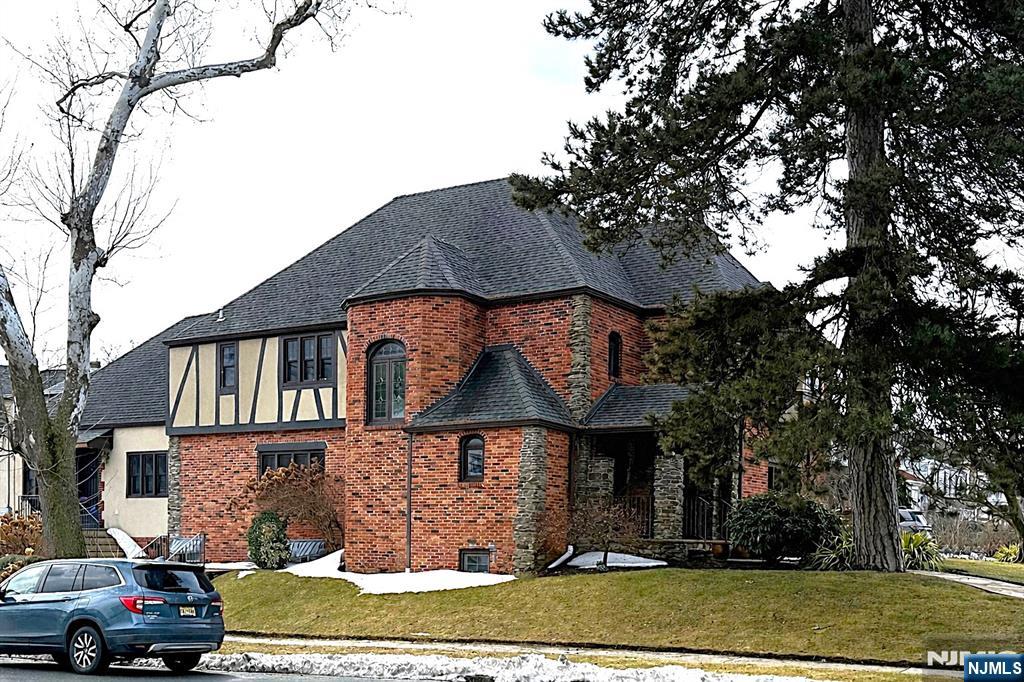 One-of-a-Kind Tudor located at Belgrove Drive Estates - One of the Most Pristine Streets in Kearny! This Spectacular Home offers Approx. 3,700 sq ft of Living Space. 1st Floor Welcomes you with a Grand Entry Foyer, Sunken Living Room with Wood-Burning Marble Fireplace, Modern Chef's Kitchen w/Center Island adjacent to the Family Room, Banquet Size Dining Room, Sun Room with Skylights & French doors, and a Powder Room. Also on the 1st Fl is a Secondary Suite with its own Separate Entrance; ideal for Professionals, Extended Family or Guests - Complete with a Living Room, 2 Bedrooms, and a Full Bath. 2nd Floor Features a Large Primary Suite w/Full Bath & Jacuzzi Tub, a Jr Suite w/its own Full Bath, 2 additional Generously Sized Bedrooms (One with a Sitting Room), and another Full Bath. Ground-Level Walk-Out Basement is Full and Partly Finished, offering a Large Rec Room, Powder Room, Laundry Room, Workshop, Utility Room and Storage. Additional Features include a Gated 4-Car Driveway, an Oversized 2-Car Garage, Outdoor Patio Area, Hardwood Floors, Indian Slate Natural Stone, Granite Countertops, 5 Zone Heating and Central Air. An Absolutely Exceptional Home that is Close to Everything - A True Must See!!!