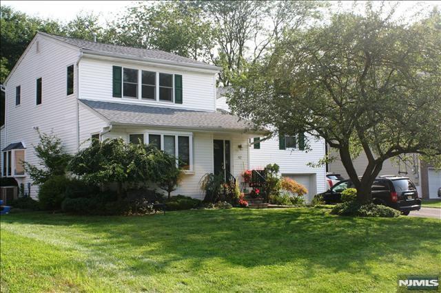Large expanded split-level home on picturesque Heatherhill Rd in Cresskill, surrounded by many new homes in a tranquil residential setting. Featuring an upper level addition with a primary bedroom-suite w/full bath & large walk-in closet. The open eat-in kitchen w/SS appliances features granite counter-tops & a center island. Main level is an open and practical living space which connects all areas in a natural flow. Other features include: entrance foyer with double closet space, large sky-lighted rear family room with sliding doors to charming rear deck, 6 bedrooms including one with own in-suite private bathroom which is in addition to the separate large primary-bedroom suite, fully fenced-in rear yard with access to family rm, central-a/c system, attached 1-car garage w/elect opener + spacious double-width driveway accommodating up to 4 additional cars. Landlord will consider pets. Quiet street & charming neighborhood, close to parks & Cresskill's excellent schools. Currently this home is still occupied by current tenants but available for a future occupancy date in early July, pictures are from previous listings in the past. Please note that Fireplace is decorative only and not for actual use.