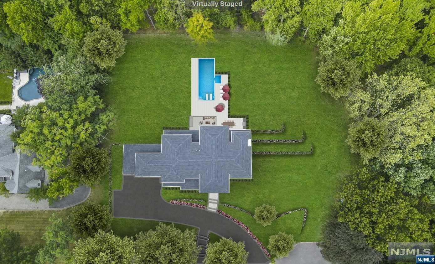 PRIVATE AND SECLUDED ONE ACRE PROPERTY ON A PRESTIGIOUS CUL-DE-SAC ON THE EAST HILL OF TENAFLY! APPROX. 8,000 SFT OF LUXURIOUS NEW CONSTRUCTION DESIGNED BY TOP NYC INTERIOR DESIGNER. FIRST FLOOR: GRAND ENTRANCE FOYER, LIVING ROOM, GREAT ROOM WITH GAS FIREPLACE, DINING ROOM, GOURMET EAT-IN KITCHEN, BUTLER'S PANTRY, BEDROOM, FULL BATHROOM, POWDER ROOM, SLIDING DOOR TO DECK. SECOND FLOOR: PRIMARY BEDROOM SUITE, PRIMARY BATH, 2 WASHROOMS, OVERSIZED WALK-IN CLOSET, STUDY/OFFICE,3 ADDITIONAL EN-SUITE BEDROOMS AND LAUNDRY ROOM. LOWER LEVEL: LARGE MEDIA ROOM, GYM, BEDROOM, FULL BATHROOM, SPACIOUS RECREATION ROOM, WINE CELLAR & FULL BATHROOM, WALK OUT TO COVERED PATIO. OUTDOOR ENTERTAINING: HEATED IN-GROUND POOL WITH AUTOMATED COVER, HOT-TUB (SEPARATE HEATING TO BE USED YEAR ROUND), OUTDOOR KITCHEN AND COVERED PATIO WITH FIREPLACE. CALIFORNIA CLOSETS IN ALL BEDROOMS, 3-CAR HEATED GARAGE, 4-ZONE A/C, FULL HOUSE GENERATOR. MINUTES TO GW BRIDGE TO NEW YORK, TOP RANKED SCHOOL