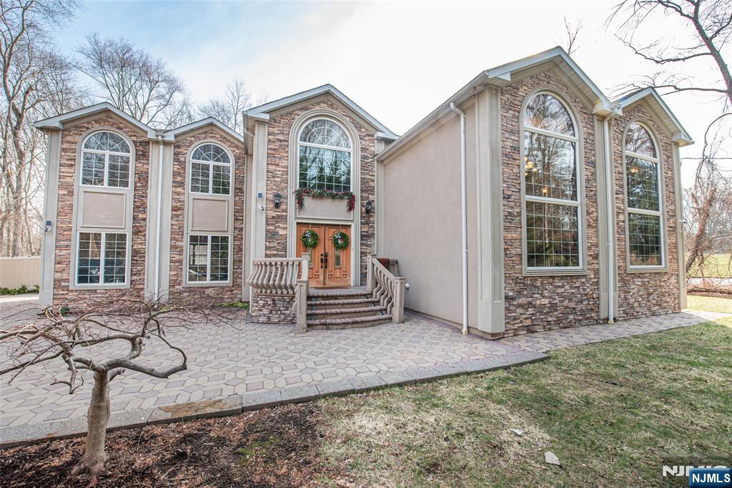 Welcome to this stunning custom-built 2006 home offering over 3,500 sq ft of beautifully designed living space with 4 bedrooms-Each bedroom has its own private full bathroom attached (an en-suite bath).Plus 1 additional (powder room) for guests 1st floor. Enter through stately double doors into a dramatic two-story foyer featuring a striking floating curved staircase, setting the tone for the home's elegant design. Freshly painted throughout, the home showcases a breathtaking great room with soaring 20-foot ceilings, oversized picture windows, and a statement fireplace, seamlessly flowing into a spacious lrm, formal dining room, and a sun-filled eat-in kitchen with natural stone countertops. The luxurious primary suite offers a private retreat with a sitting area, gas fireplace, walk-in closet, and spa-like bath, while the 2nd level features a Juliette balcony and a convenient 2nd-floor laundry. Step outside to a private, park-like backyard with mature landscaping and an in-ground heated saltwater pool that is now open (new liner being installed)) Sold as is.Additional highlights include a 2-car garage with newer doors, central air, a whole-house speaker system, a surveillance system, and an exterior utility room providing access to Unfin Basement crawl space for added storage & you can stand in it. Entrance from outside of home.Completing this exceptional home that blends luxury, comfort, and functionality. Close to train.Buyer could not perform. Back on the market.