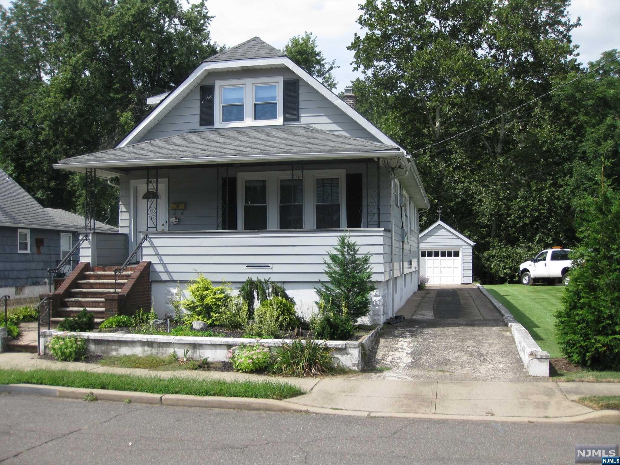 This charming home has everything your apartment doesn't. Walking into the foyer you're greeted with beautiful double glass doors and large coat closet. The first level has gorgeous chestnut trim, stained glass windows, and wood flooring. You also have a spacious living room with built in cabinets, formal dining room, large eat in kitchen with a walk in pantry, two bedrooms and a full bath. The second level can be used as an in-law suite with an eat in kitchen, living room/den, full bath and a bedroom - the second floor was recently renovated. The full unfinished basement has more than enough room to store all of your belongings. The home is finished off with the adorable lemonade porch, 1 car detached garage and parking for 4 cars.