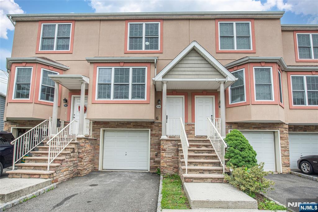Thoughtfully renovated from top to bottom, this turnkey townhouse in Grandview Commons offers three levels of comfortable living with modern updates throughout. A private garage with interior access leads to the ground level, featuring a recreation room with walk out access to the patio and a conveniently located laundry area. The main living level showcases hardwood flooring, recessed lighting, and an open concept living and dining area filled with natural light from a large bay window. The renovated kitchen features white upper cabinetry, warm wood lower cabinets, quartz countertops with a matching full height backsplash, stainless steel appliances, a center island with seating, and a bright breakfast area surrounded by windows. Upstairs, the bedroom level offers two spacious bedrooms and two full baths. The primary suite easily accommodates a king size bedroom set with room for a sitting area or workspace and includes dual his and hers closets and a private en suite bath. The second bedroom offers generous closet space and abundant natural light. Conveniently located near NJ Transit, major highways, shopping, restaurants, parks, and just minutes from Montclair, this move in ready home offers stylish finishes, generous living space, and exceptional everyday convenience.