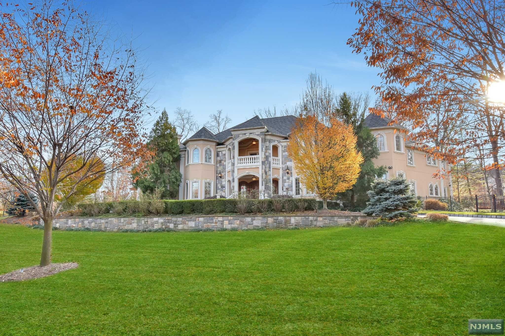 Enter through the magnificent 2-story foyer with double bridal staircase into this amazing 10,000 sq. ft estate with custom millwork, crown moldings, cherry hardwood and marble flooring throughout. No expense was spared in every detail of this spectacular 7 bedroom, 8 full and 2 half bath home. The open floor plan on the first level boasts the formal living and dining rooms, family room with coffered ceilings and fireplace, study/office and poker/gaming room. The chef's dream eat-in kitchen boasts stainless steel appliances, custom cabinetry, double granite islands & breakfast room with fireplace. The over-sized master suite is complete with a luxurious master bathroom, 2 fireplaces, two walk-in closets and 2 private balconies. Completing the second floor are 4 additional bedroom suites with full baths & walk-in closets. The 3 car attached garage, full finished lower level, beautiful backyard, outdoor kitchen and in-ground swimming pool make this the perfect home for entertaining!