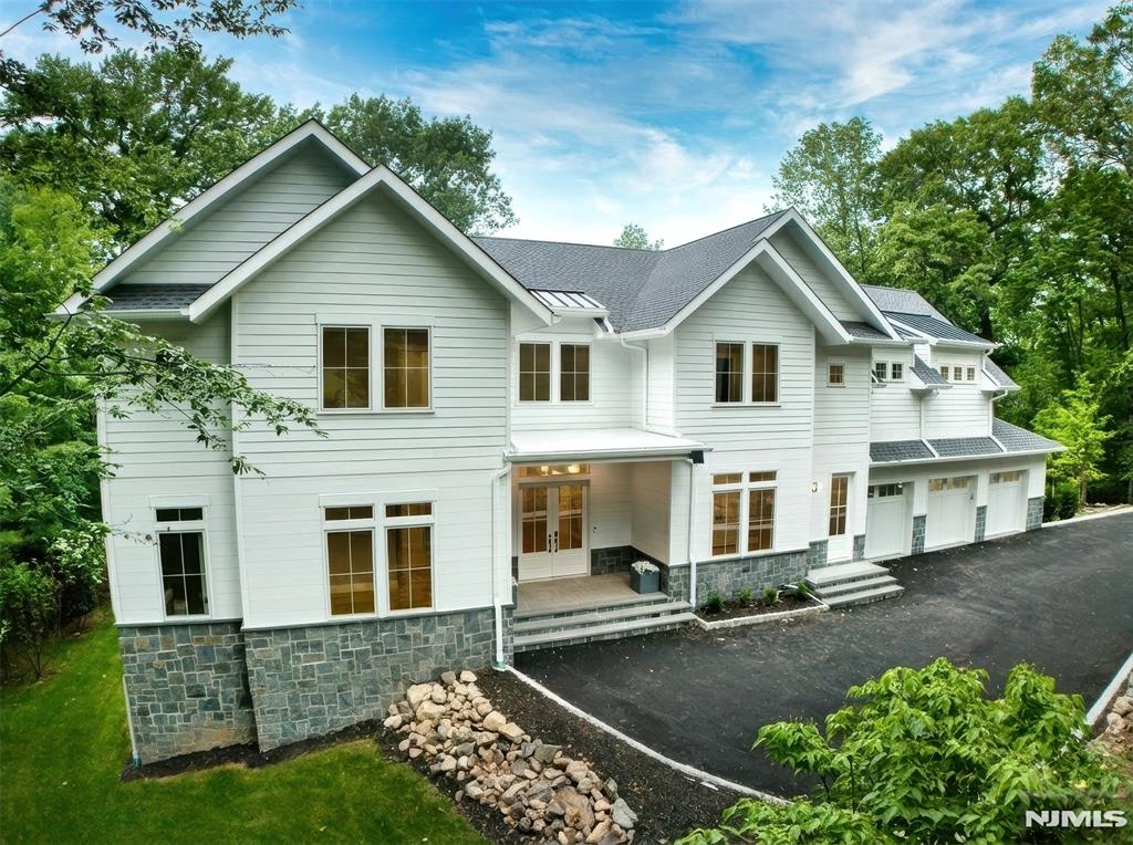 A masterful blend of timeless architecture and contemporary design, this new construction luxury residence is nestled in Englewoodâ€™s prestigious East Hill neighborhood. Offering approximately 9,600 square feet of impeccably designed living space and just minutes from New York City. A dramatic two-story entry welcomes you into extraordinary interiors highlighted by soaring ceilings, architectural beams, custom millwork, wide-plank white oak floors, and designer finishes. Spectacular great room with fireplace flows seamlessly into a state-of-the-art chefâ€™s kitchen featuring dual islands, premium appliances, custom cabinetry, large walk-in pantry and a stylish wet bar...a perfect setting for both intimate family living and grand-scale entertaining. The home offers 7 spacious bedrooms, 8 full bathrooms, and 1 half bath. luxurious primary suite with vaulted ceilings, a fireplace, private balcony, custom dressing room, and spa-inspired bath with radiant heated floors. Full finished walk-out lower level is designed for recreation and entertainment including a lounge bar, guest bedroom, gym, home theater, and direct access to the rear yard. Additional highlights include covered all-season patio complete with a built-in outdoor kitchen, fireplace, and overhead heaters, a three-car garage, smart home technology, whole-house generator, EV charging capability, and room for a pool. Estimated taxes are approximately $61,600 per assessor based on plans. An Englewood must see!