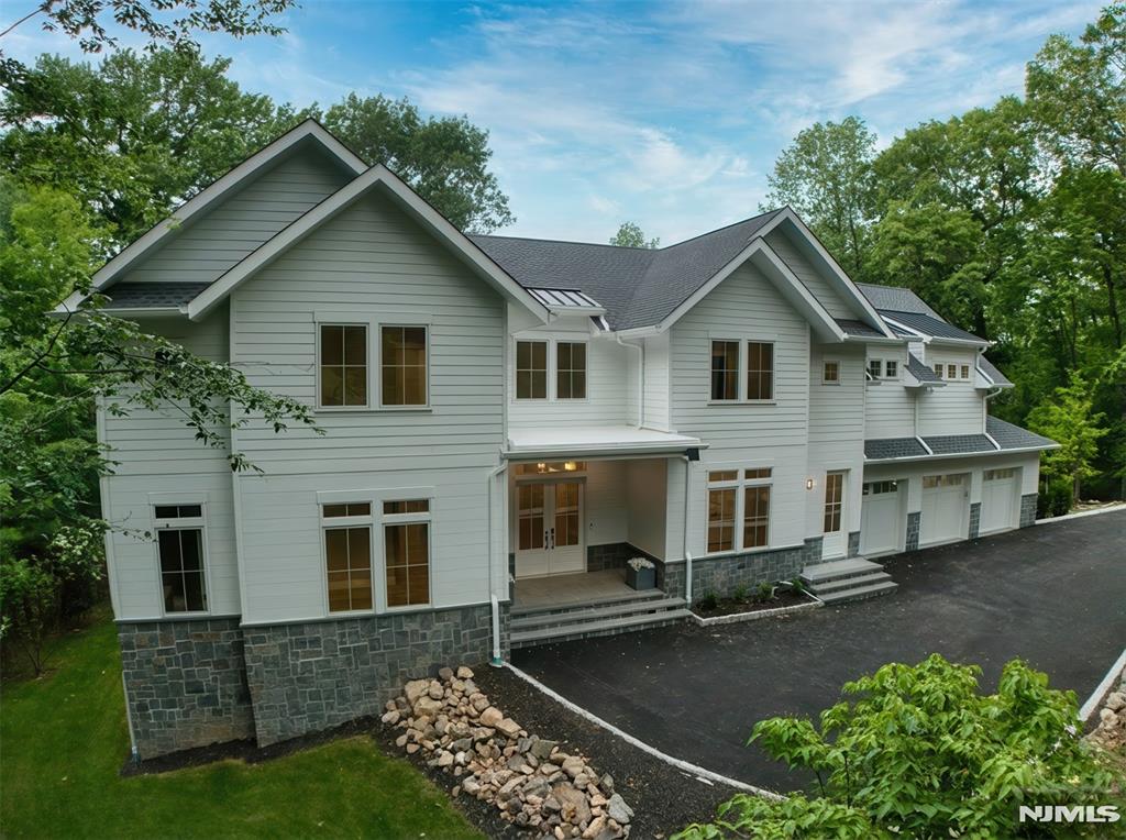 A masterful blend of timeless architecture and contemporary design, this new construction luxury residence is nestled in Englewoodâ€™s prestigious East Hill neighborhood. Offering approximately 9,600 square feet of impeccably designed living space and just minutes from New York City. A dramatic two-story entry welcomes you into extraordinary interiors highlighted by soaring ceilings, architectural beams, custom millwork, wide-plank white oak floors, and designer finishes. Spectacular great room with fireplace flows seamlessly into a state-of-the-art chefâ€™s kitchen featuring dual islands, premium appliances, custom cabinetry, large walk-in pantry and a stylish wet bar...a perfect setting for both intimate family living and grand-scale entertaining. The home offers 7 spacious bedrooms, 8 full bathrooms, and 1 half bath. luxurious primary suite with vaulted ceilings, a fireplace, private balcony, custom dressing room, and spa-inspired bath with radiant heated floors. Full finished walk-out lower level is designed for recreation and entertainment including a lounge bar, guest bedroom, gym, home theater, and direct access to the rear yard. Additional highlights include covered all-season patio complete with a built-in outdoor kitchen, fireplace, and overhead heaters, a three-car garage, smart home technology, whole-house generator, EV charging capability, and room for a pool. Estimated taxes are approximately $61,600 per assessor based on plans. An Englewood must see!