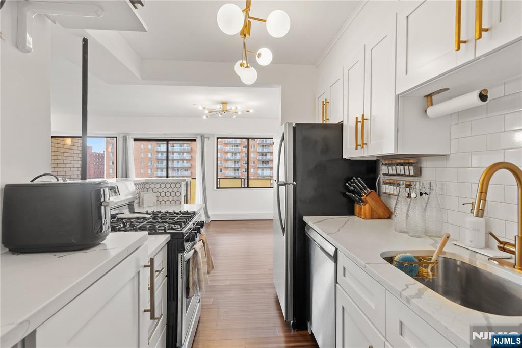 his newly renovated 1-bedroom, 1-bathroom condo offers a modern and comfortable living space with all the amenities you need. Featuring a spacious living room and bedroom that are bathed in natural light, this unit creates a bright and welcoming atmosphere throughout. Enjoy stunning NYC views right from your bedroom in this recently renovated apartment. All updates were completed within the past year. The kitchen features elegant quartz countertops, and the floors are beautifully crafted bamboo. Relax or entertain in style on the spacious balcony. Additional amenities include an exercise room for your fitness needs and a doorman for added convenience and security. The unit also comes with 1 parking spot, a rare and valuable feature. Located just minutes from NYC transportation, this condo provides an ideal balance of tranquility and accessibility, making commuting a breeze.
