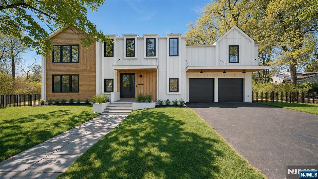 Originally offered at $2.125M with in-ground pool package, 23 Cherry Ct is now available at $1.925M, giving buyers flexibility to create their own outdoor vision while enjoying exceptional value in a newly constructed luxury home. 23 Cherry is a newly built modern barn-style residence offering 5 bedrooms, 4.5 baths, office, and over 4,500 square feet of thoughtfully designed living space on a rare 17,000-square-foot lot, tucked away on a quiet cul-de-sac. Designed for today's lifestyle, the home features an open floor concept, 9-foot ceilings on both levels, dramatic vaulted spaces, and oversized windows. White oak flooring throughout, complementing the warm, minimalist California-inspired design aesthetic. At the center of the home is a stunning chef's kitchen featuring flat-panel cabinetry, Taj Mahal quartz countertops and backsplash, 10-foot center island, and premium Bertazzoni appliances. Two oversized sliding glass doors create seamless indoor-outdoor living and entertaining. The first floor includes a private en-suite bedroom as well as a stylish powder room. Upstairs, you'll find three additional bedrooms, a dedicated office, and two full bathrooms with tubs. The luxurious primary suite showcases vaulted ceilings, expansive windows overlooking the property, a custom white oak closet system, and a spa-inspired bath complete with a soaking tub and double vanity. The finished basement provides additional flexible living space, perfect for a home gym or media room.