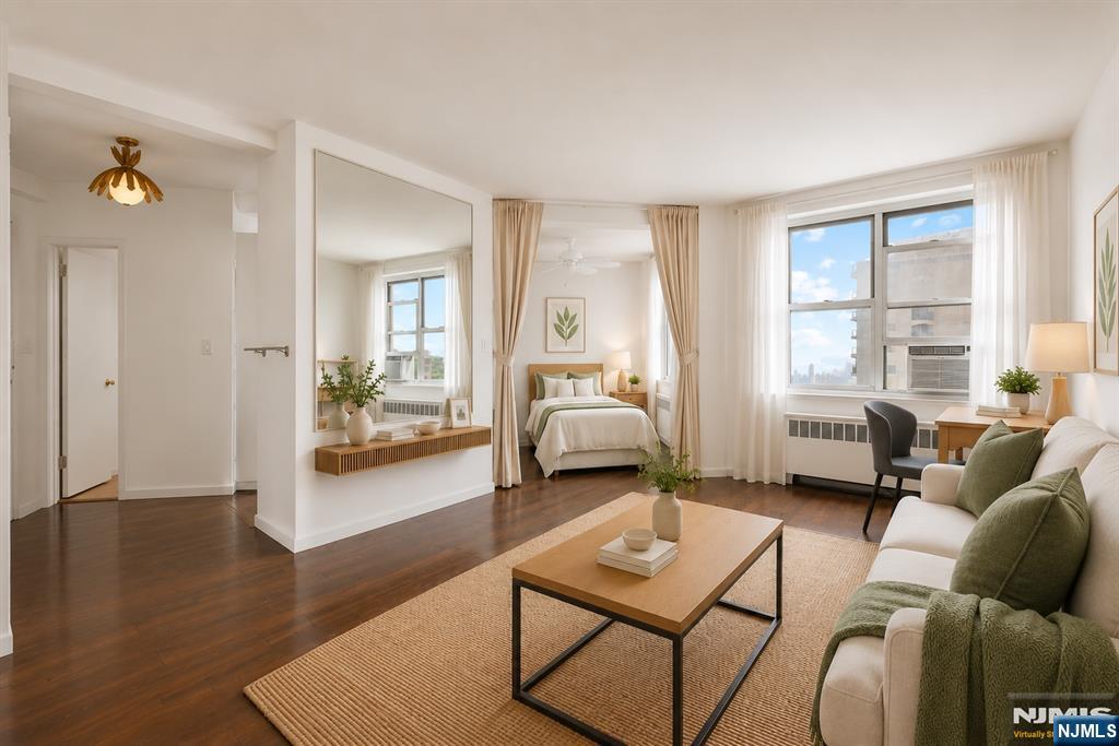 Rarely available top-floor studio in the highly desirable town of Fort Lee! This thoughtfully designed 501 sqft home features a functional layout complete with a separate sleeping alcove. Enjoy stunning southern exposure, abundant natural light, and beautiful Hudson River views. Inside, you'll find classic hardwood floors, a modern kitchen, and excellent closet space. Best of all, your HOA fee covers all utilities: heat, hot water, water, and electricity. Positioned within easy walking distance to local shopping, dining, and direct NYC transit, this unit offers the perfect blend of comfort and convenience.