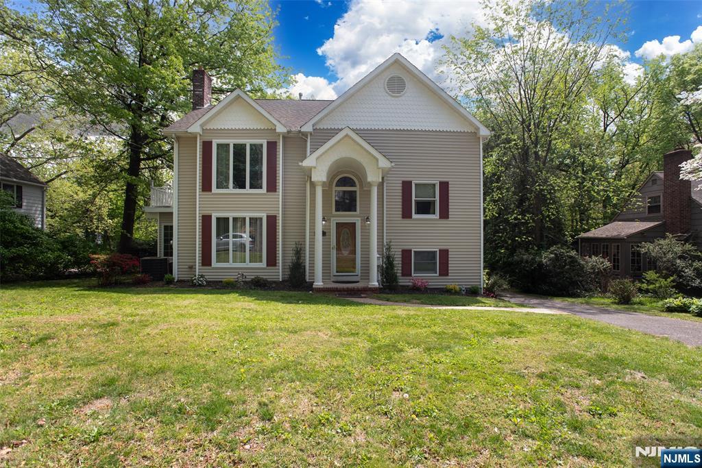 Nestled in one of Westfield's most desirable neighborhoods, this exceptional custom Colonial blends timeless elegance with modern comfort. Just one block from Washington School and less than a mile from downtown Westfield and NJ Transit, the location is hard to beat. The main level features a formal living room with a gas fireplace, an elegant dining room, and a chef-inspired kitchen with premium stainless steel appliances, under-cabinet lighting, and an expansive breakfast bar. Anderson windows and doors throughout provide abundant natural light and energy efficiency. French doors open to a wraparound Trex deck overlooking a private, park-like backyard perfect for entertaining or relaxing. The upper levels offer spacious bedrooms and a luxurious primary suite featuring a gas fireplace, walk-in closet, jetted tub, steam shower, and a bright skylit loft ideal for a home office, sitting area, or potential fifth bedroom. The walk-out basement offers outstanding flexibility with high ceilings, a full bath, second laundry area, and two private entrances ready to be finished as a recreation room, gym, guest suite, or work-from-home space. Additional highlights include 3-zone heating and cooling, 200-amp electric service, built-in speakers, ample storage, and a one-car garage. Don't miss out on this rare opportunity to enjoy exceptional space, comfort, and convenience in the heart of Westfield.