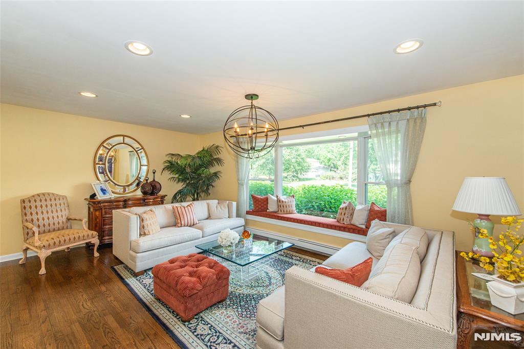Meticulously maintained and beautifully updated, this 4-bedroom, 2.5-bath home is nestled on a picturesque half-acre in one of Pine Brook's most desirable neighborhoods. Designed for today's lifestyle, the open floor plan seamlessly connects the living room, dining room and stunning updated kitchen, creating the perfect setting for everyday living and entertaining.French doors from the dining room open to an expansive maintenance-free deck overlooking the spectacular park-like backyard. A spacious patio below extends the outdoor living space, ideal for outdoor dining, gatherings, or simply relaxing while enjoying the beautifully landscaped grounds.The ground level features an expanded family room with a fireplace, offering a warm and inviting retreat for movie nights, game days, or casual get-togethers. Upstairs, the primary suite offers generous closet space and an updated private bath, while three additional bedrooms provide flexibility for family, guests, or a home office.A finished basement adds valuable living space for recreation, fitness, work-from-home needs, or a playroom. Additional highlights include custom millwork, replacement windows throughout, hardwood flooring, central air, central vacuum and pride of ownership evident at every turn.Combining timeless appeal, thoughtful updates, exceptional indoor and outdoor living spaces, and a sought-after Pine Brook location, this is a home you'll be proud to call your own.